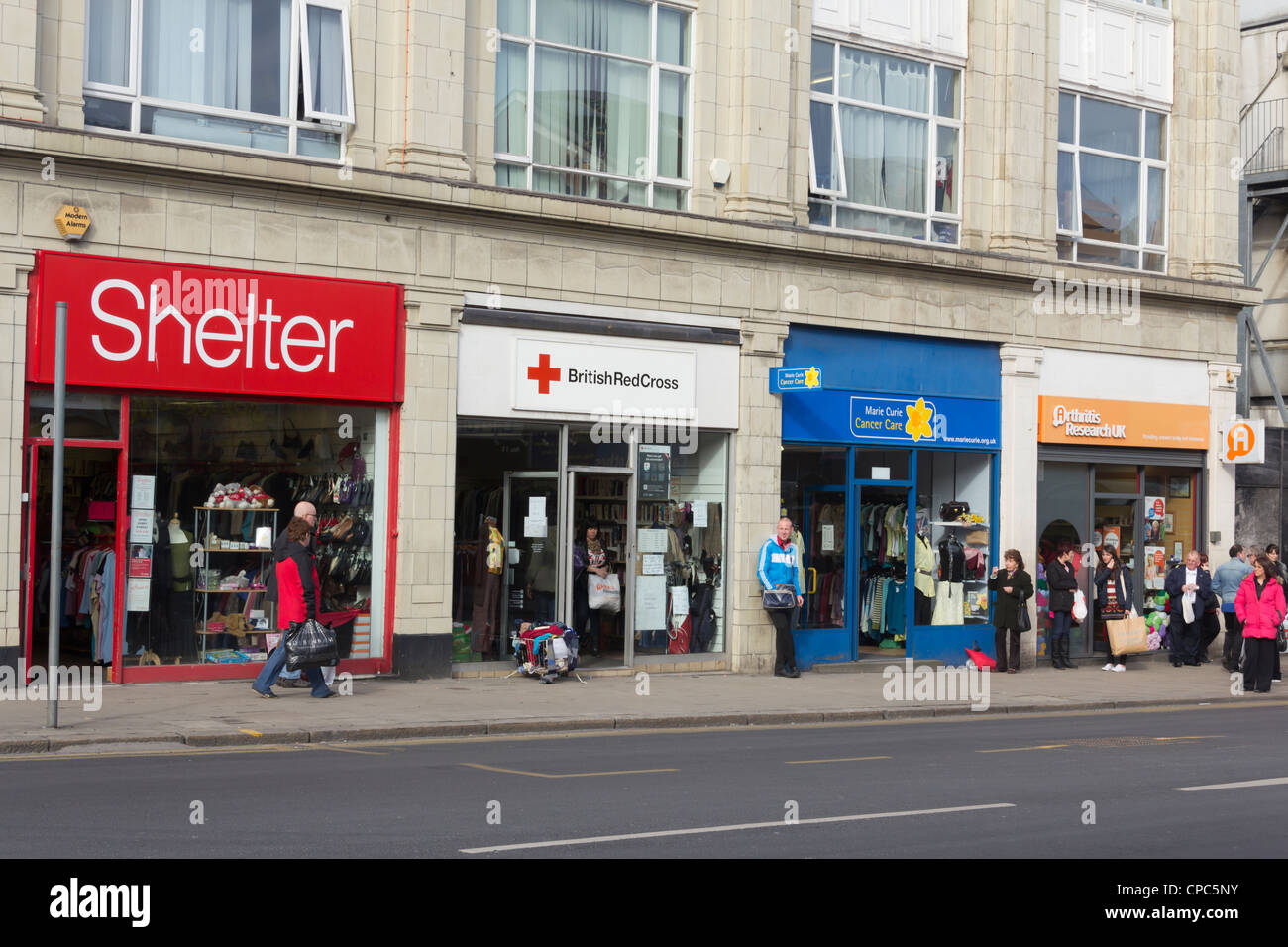 A row of four charity shops, Shelter, British Red Cross, Marie Curie and Arthiritis Research UK on Great Moor Street in Bolton. Stock Photo