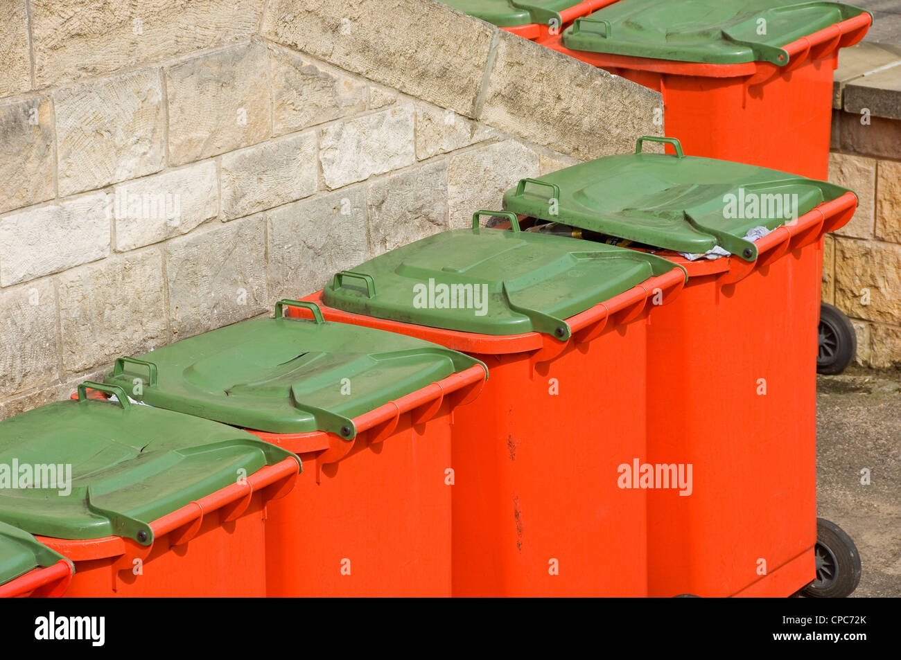 Row of commercial large waste wheelie bin bins England UK United Kingdom GB Great Britain Stock