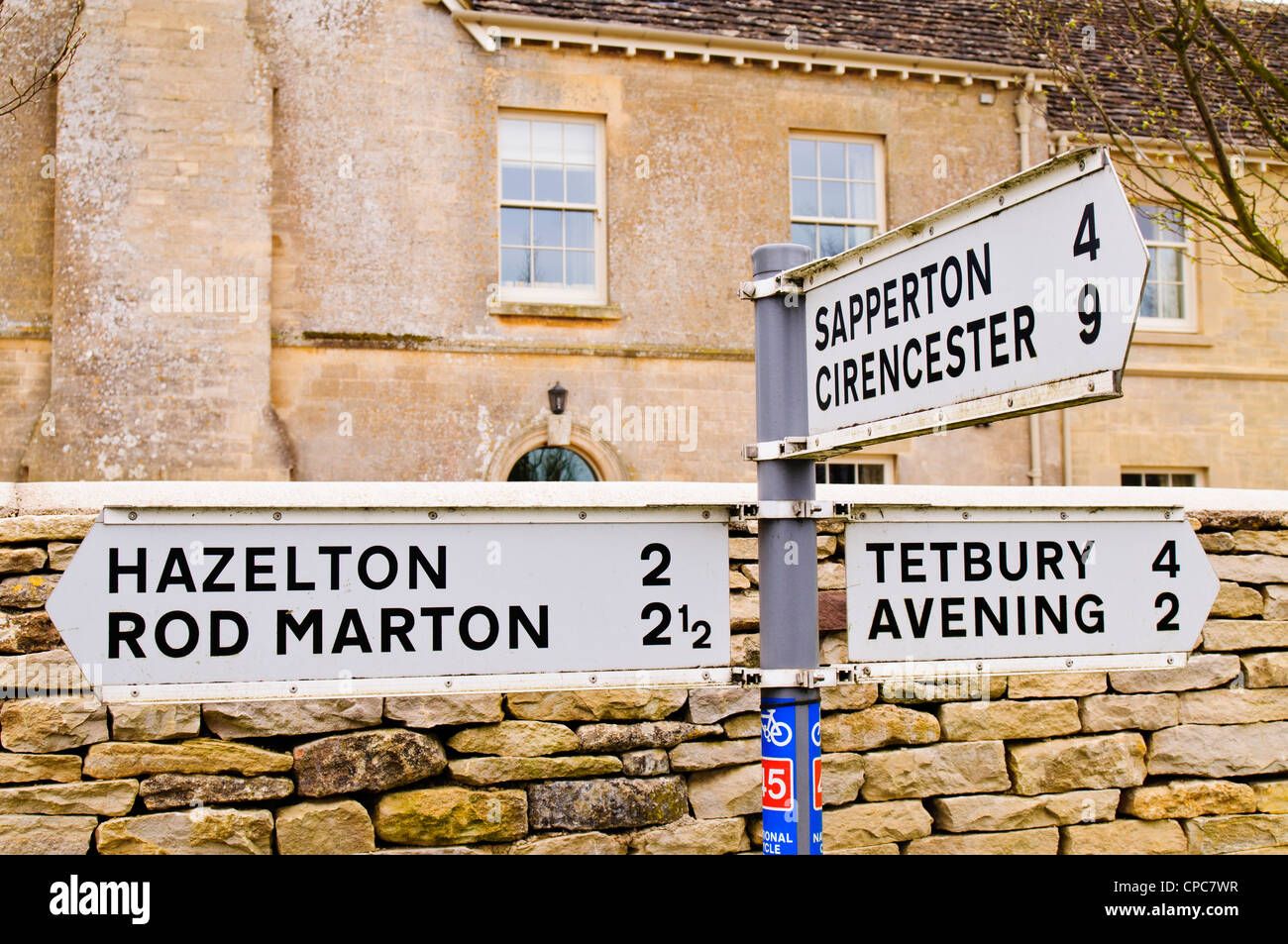 Signpost pointing directions for various Cotswold Villages in Cherington, Gloucestershire, UK Stock Photo