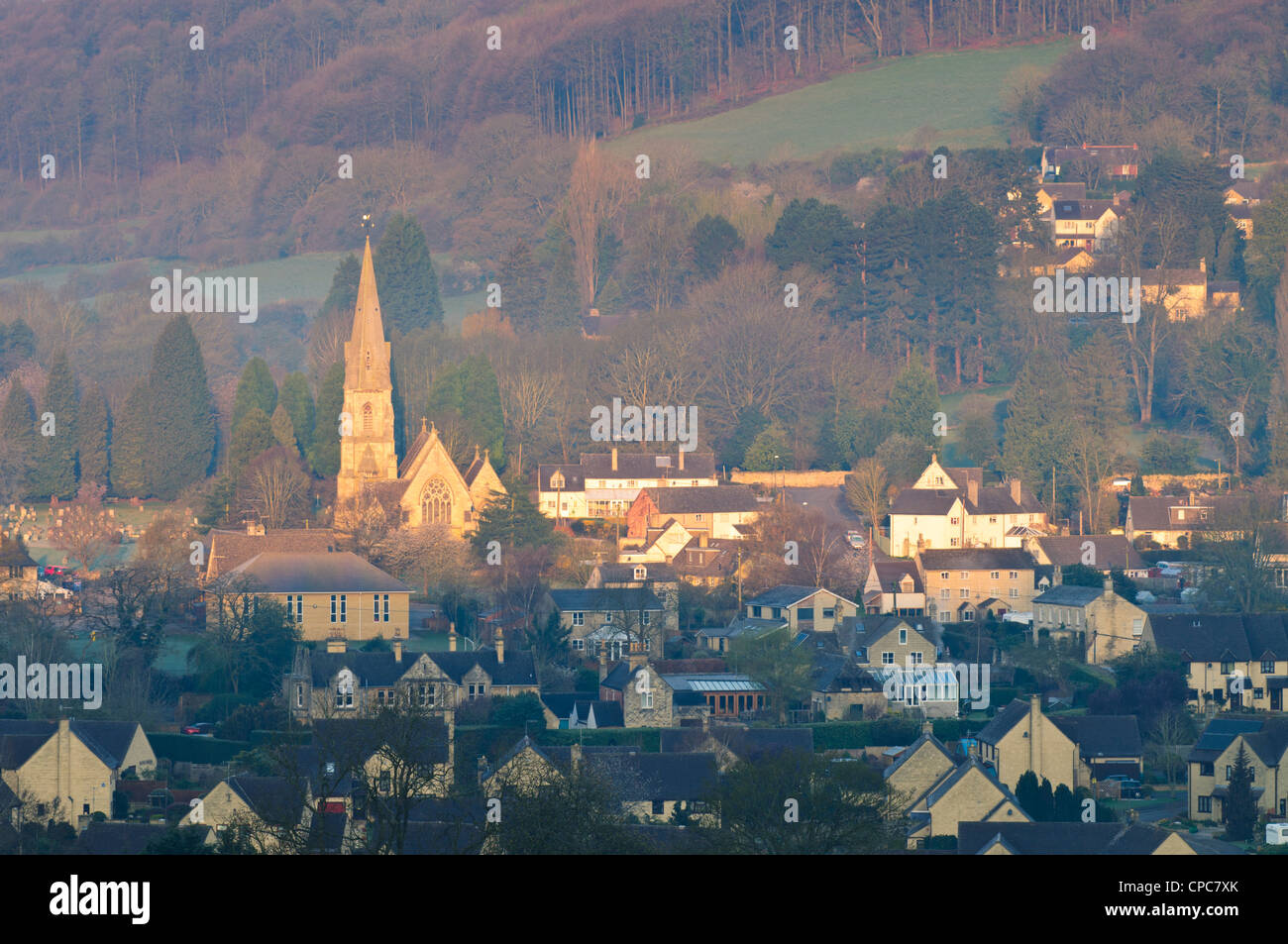 The Parish Church of St Mary and village houses in early morning light, Woodchester, Gloucestershire, Cotswolds, UK Stock Photo