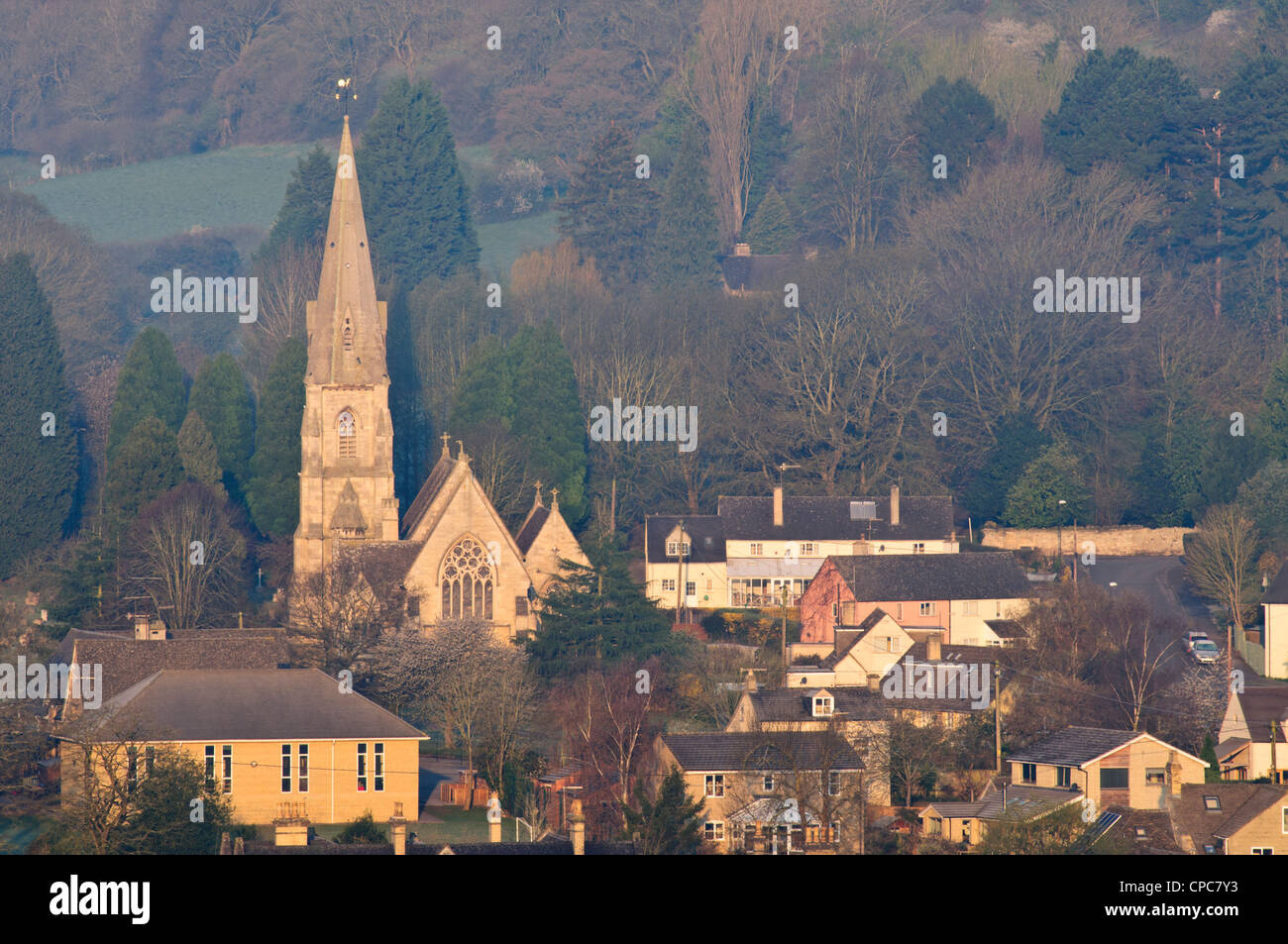 The Parish Church of St Mary and village houses in early morning light, Woodchester, Gloucestershire, Cotswolds, UK Stock Photo