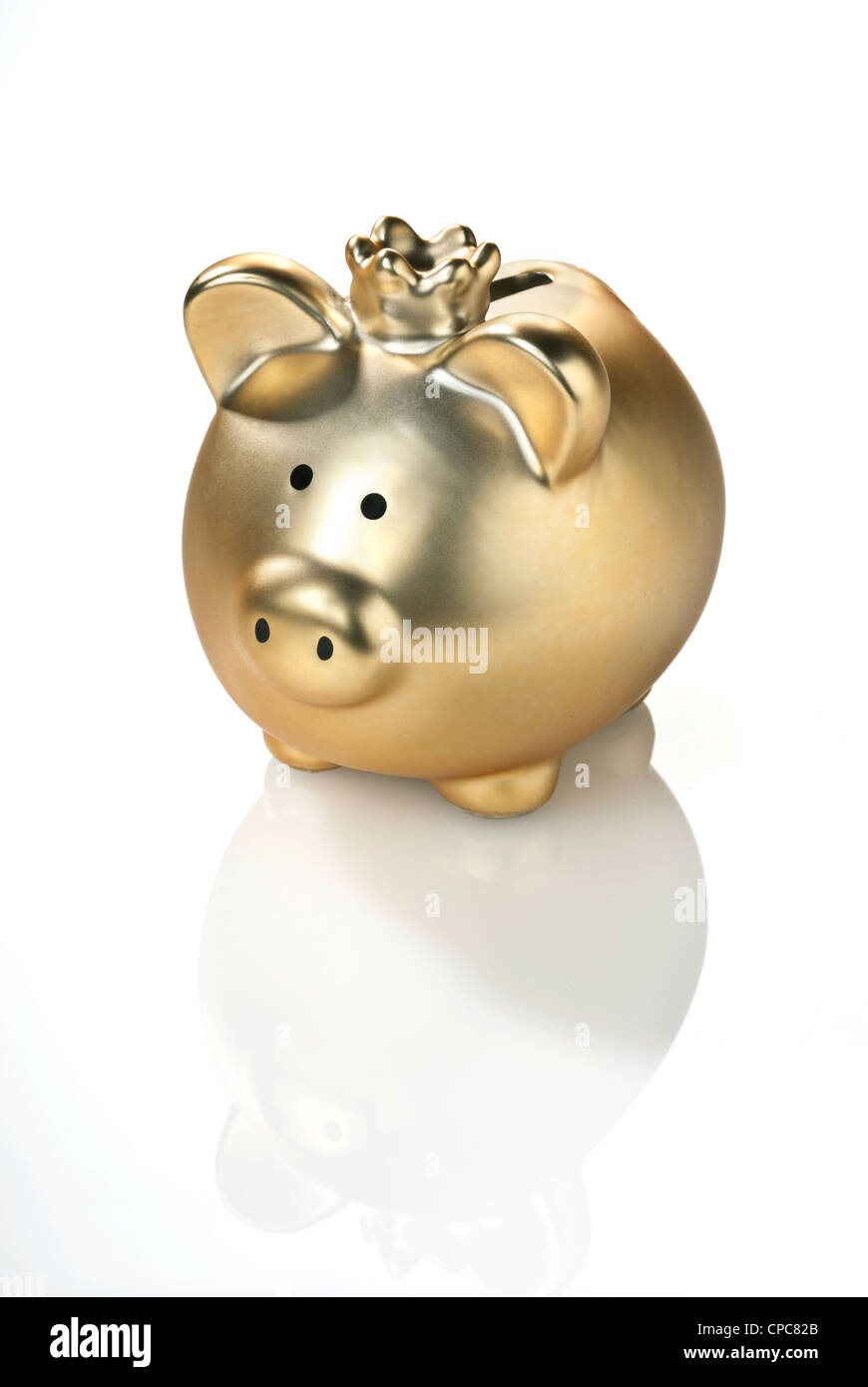 Golden piggy bank with a crown isolated on white background. Stock Photo