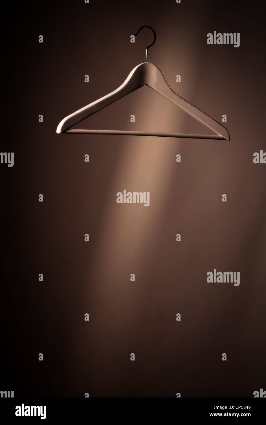 A hanger floats in front of a dark background. Stock Photo