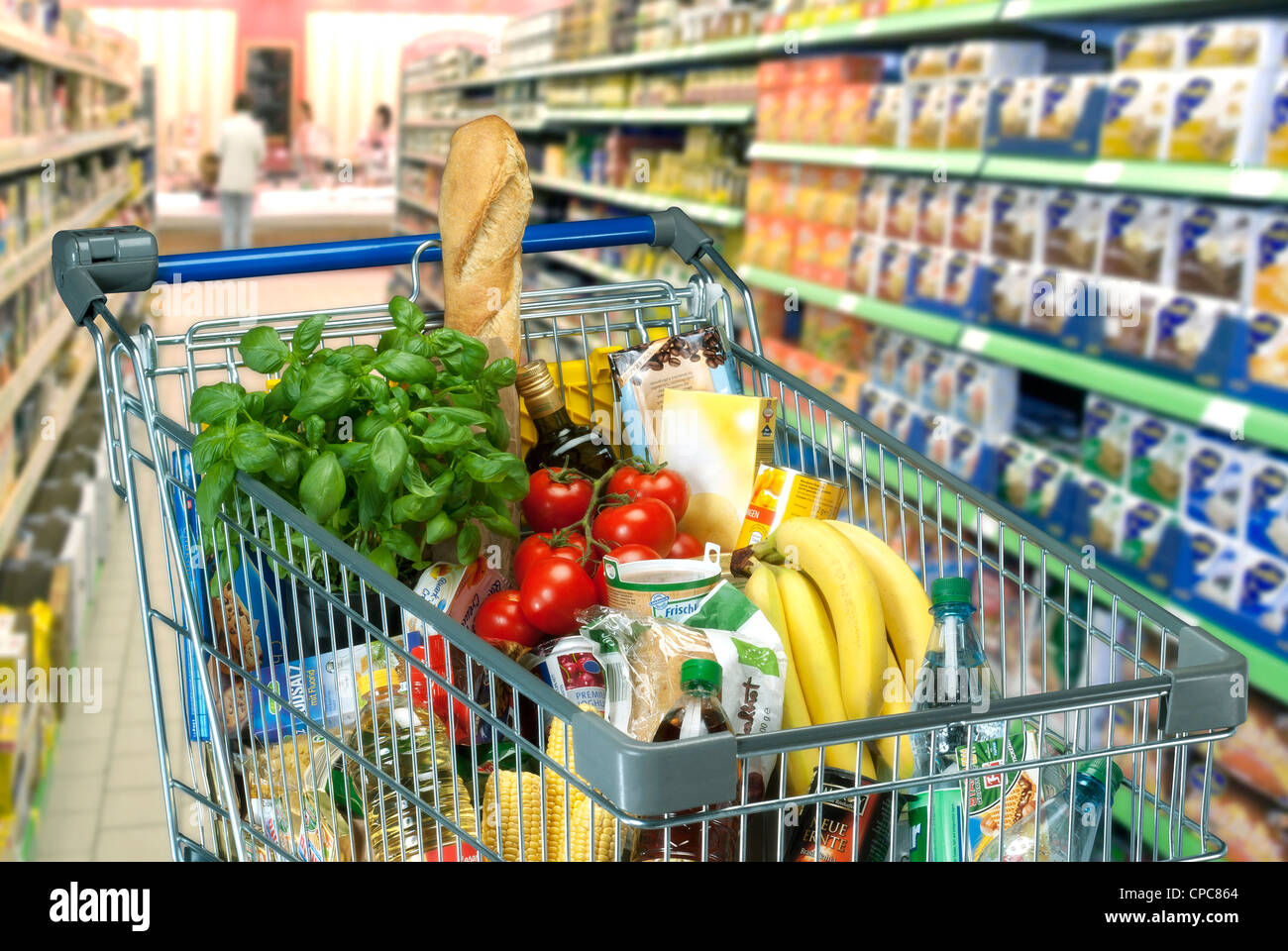 Food in a shopping trolley in a supermarket. Stock Photo