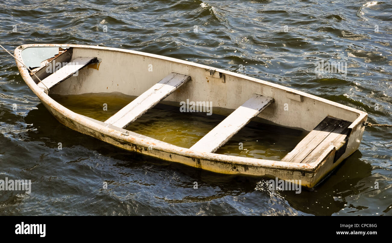 leaky life boat filled with water Stock Photo