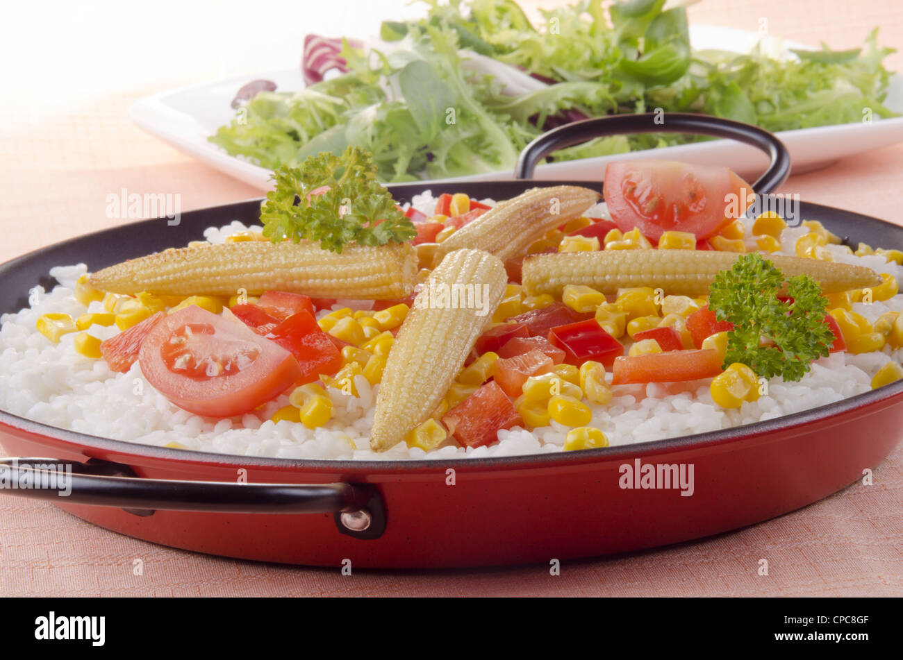 spanish vegetable paella with bell pepper, sweet corn and pea Stock Photo