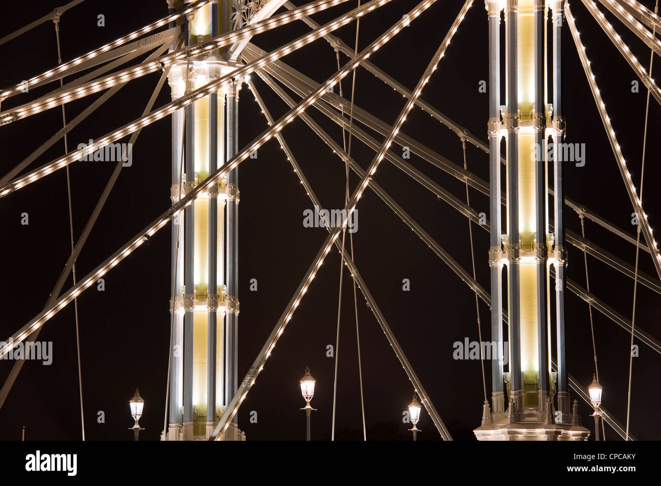 A section of Albert Bridge London crossing the River Thames from Battersea to Chelsea with Victorian lights and LED lighting on Stock Photo