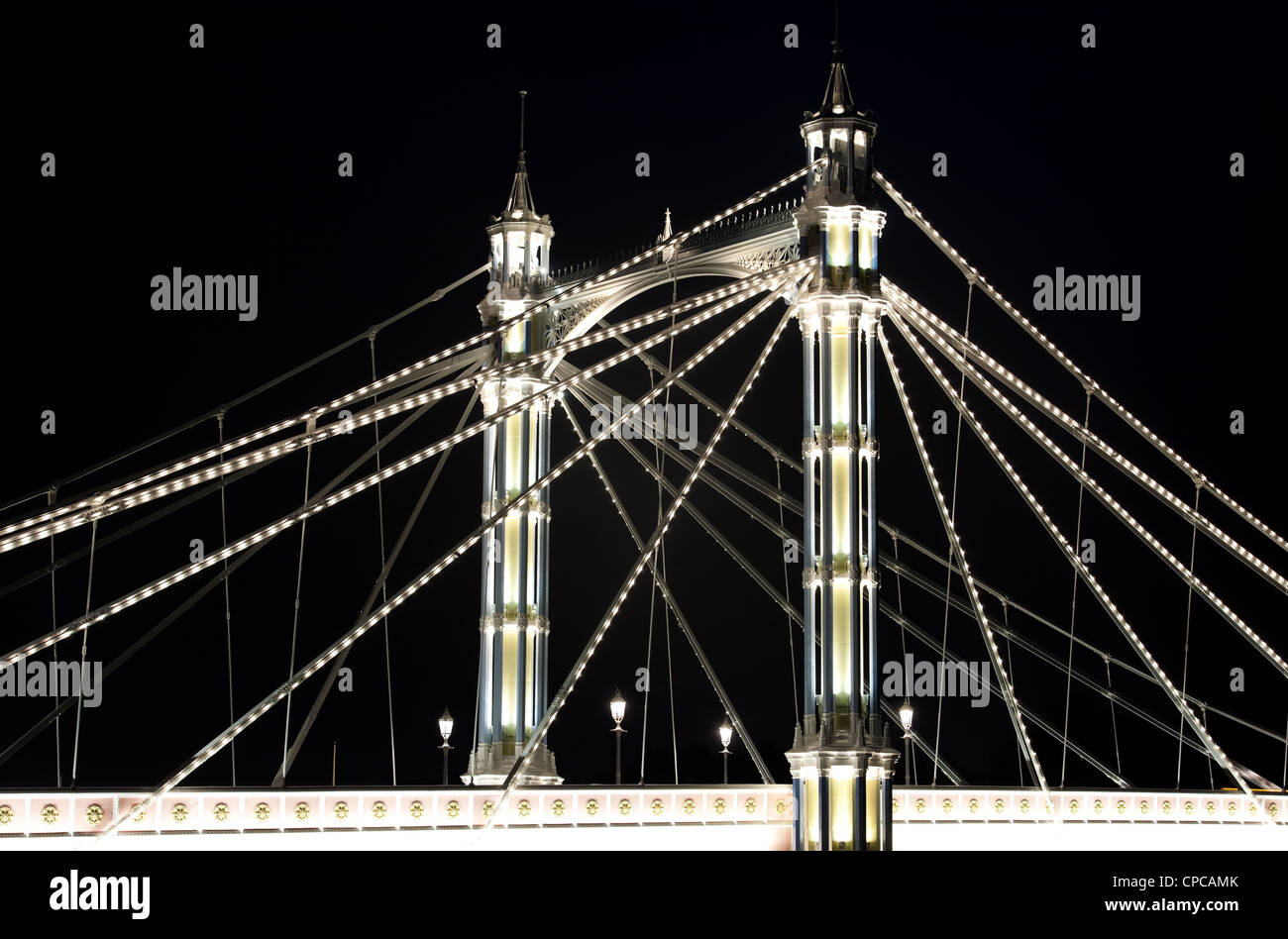 A section of Albert Bridge London crossing the River Thames from Battersea to Chelsea with Victorian lights and LED lighting on Stock Photo