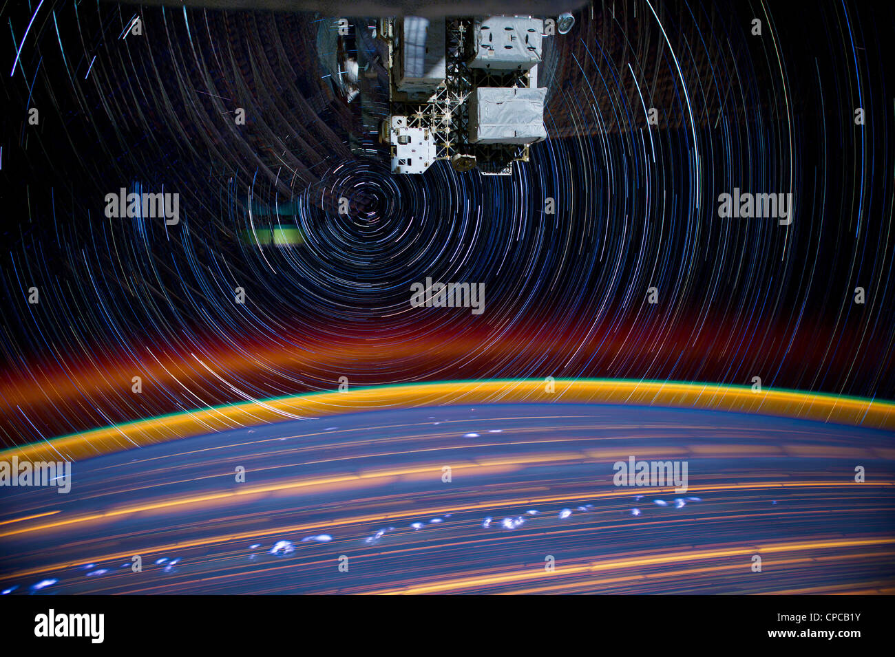 Composite series of images photographed from a mounted camera on the Earth-orbiting International Space Station showing star trails as they orbit 240-miles above Earth. A total of 18 images photographed by the astronaut-monitored stationary camera were combined to create this composite. Stock Photo