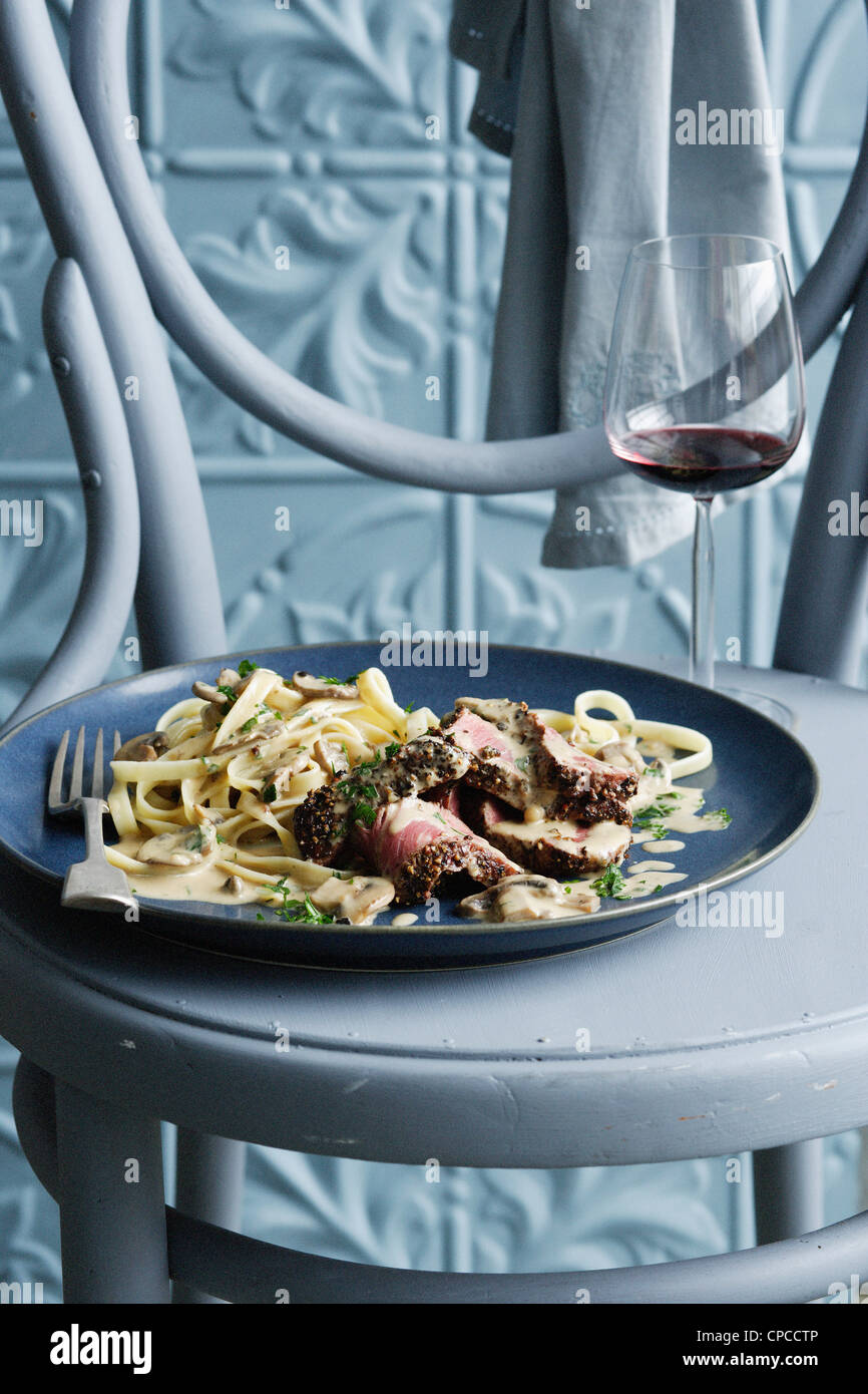 Bowl of beef stroganoff with wine Stock Photo Alamy