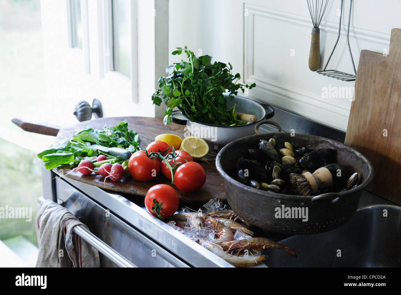 Seafood and produce on kitchen counter Stock Photo