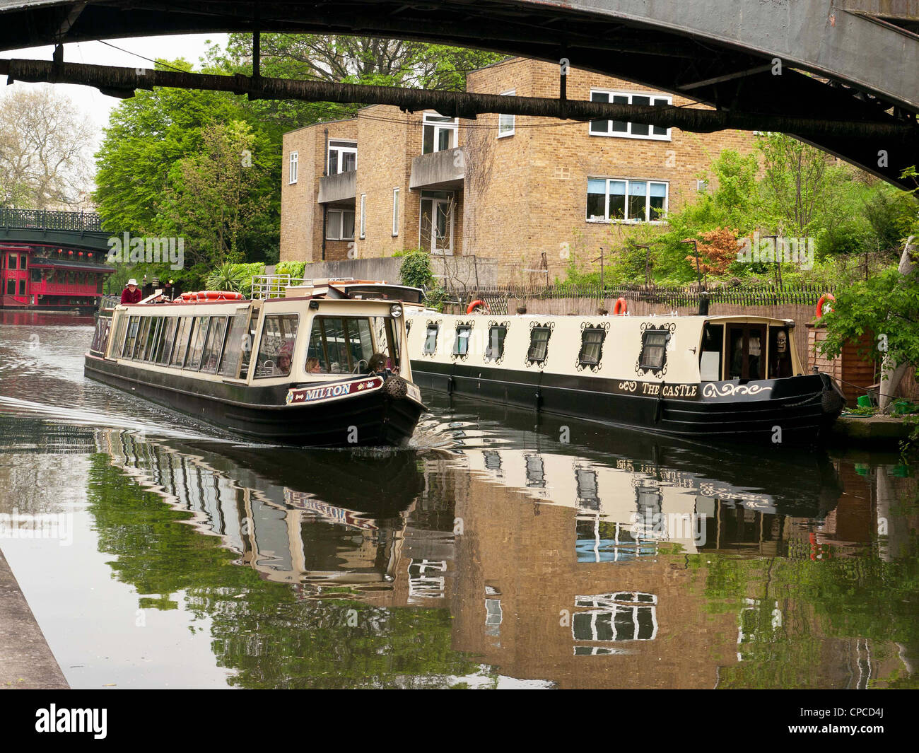 Houseboats and narrow boats under a bridge in Little Venice, Paddington, West London, on the Grand Union Canal West London UK Stock Photo