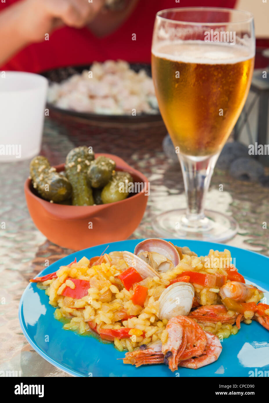 seafood paella on a bright plate, set outdoors Stock Photo