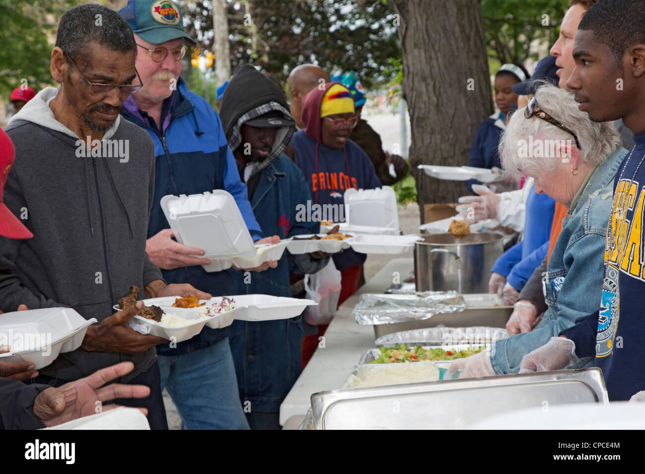 Volunteers feed homeless people america hires stock photography and