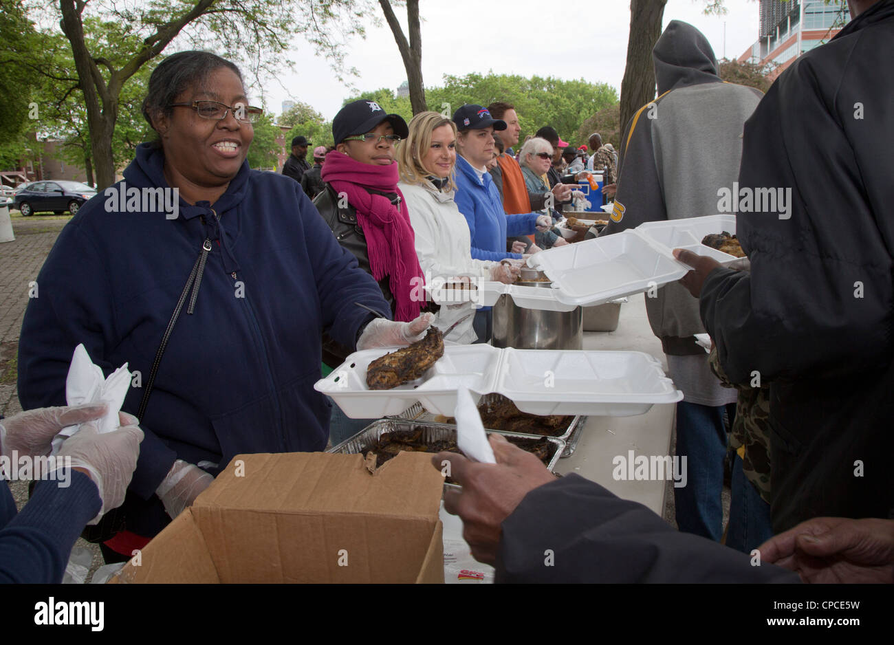 Detroit, Michigan Volunteers feed homeless people from tables set up