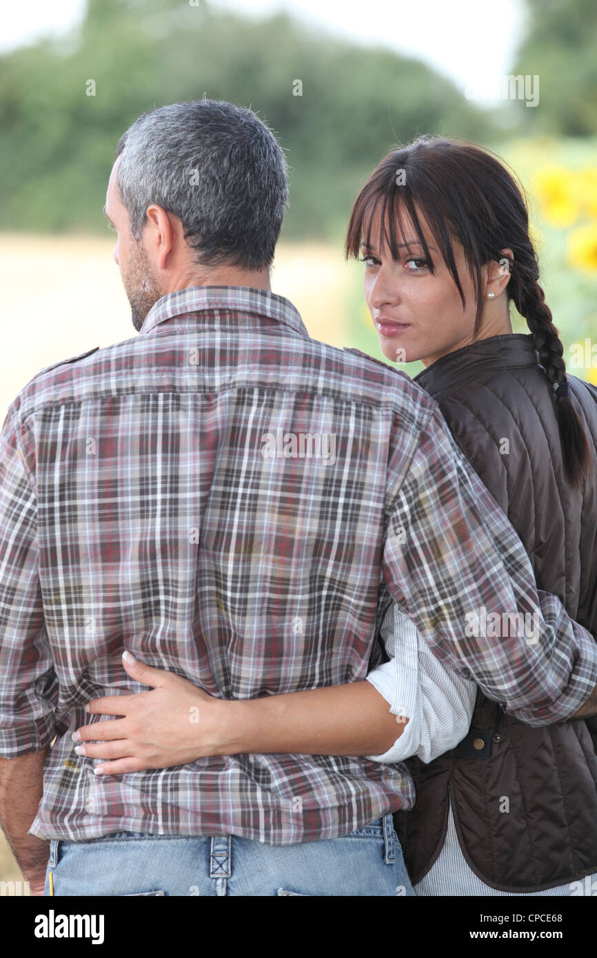 Couple walking arm in arm Stock Photo Alamy