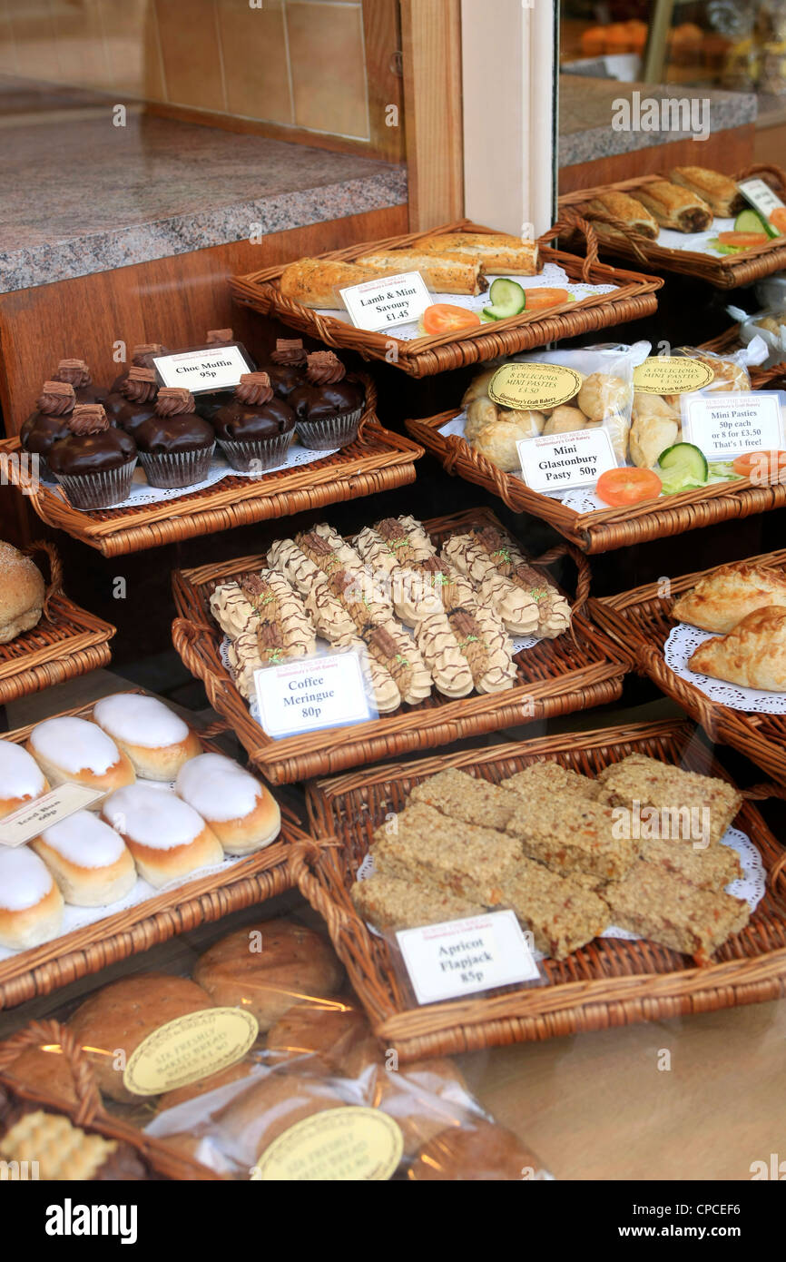 Pastries and cakes in the window of a bakery shop in England Stock