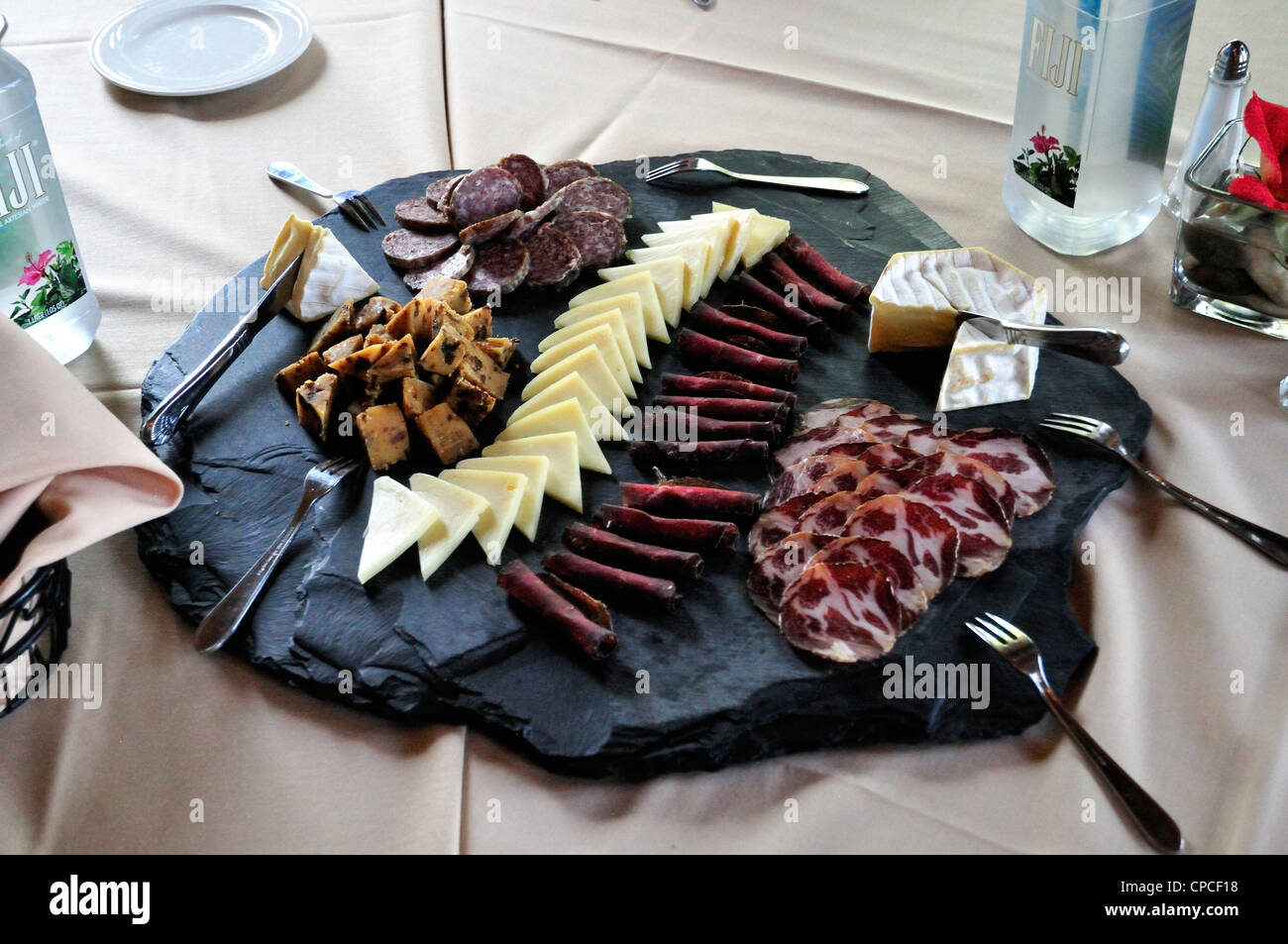 A plate containing cheeses and cold cuts, part of a lunch serving at Café Champagne Stock Photo