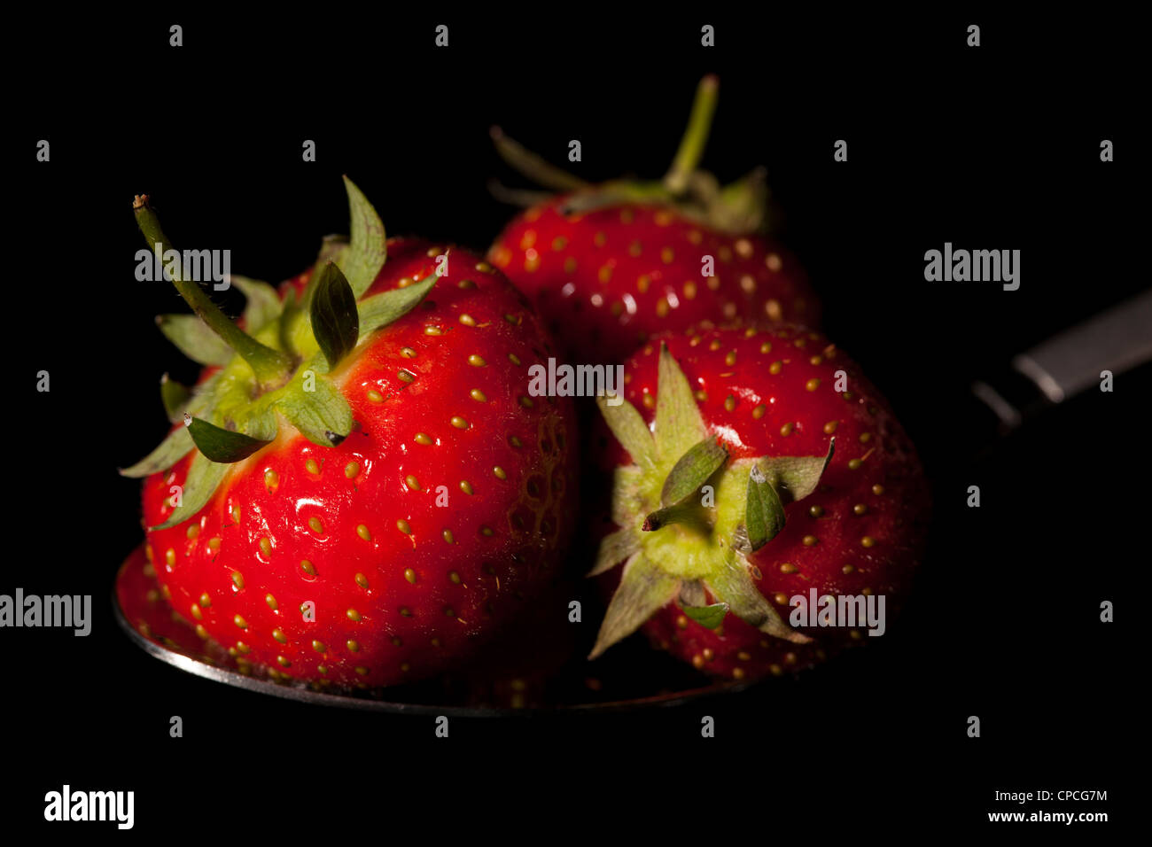 Fresh strawberries resting on a spoon, still life Stock Photo - Alamy
