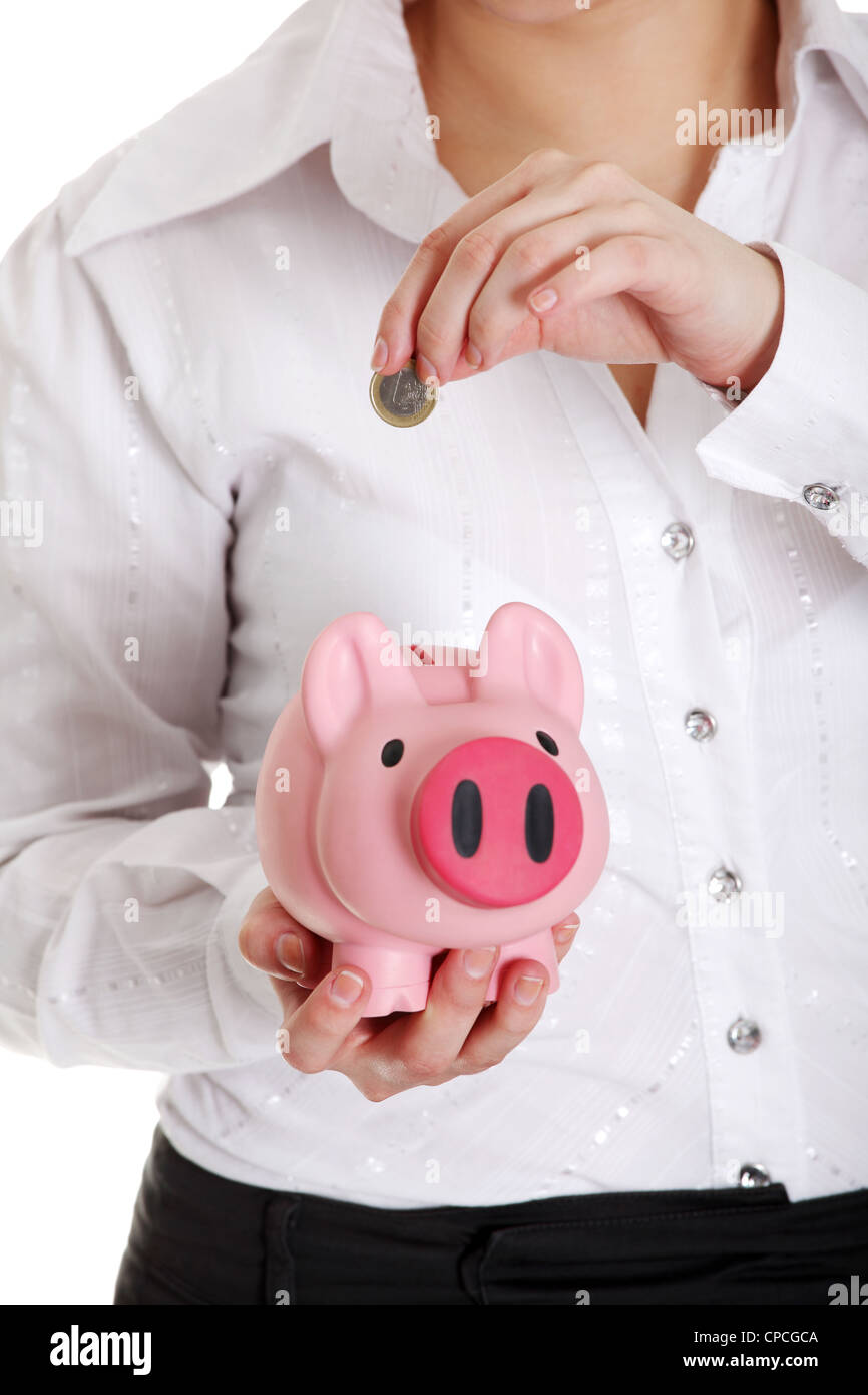 Woman putting euro coin in piggy bank. Isolated Stock Photo - Alamy