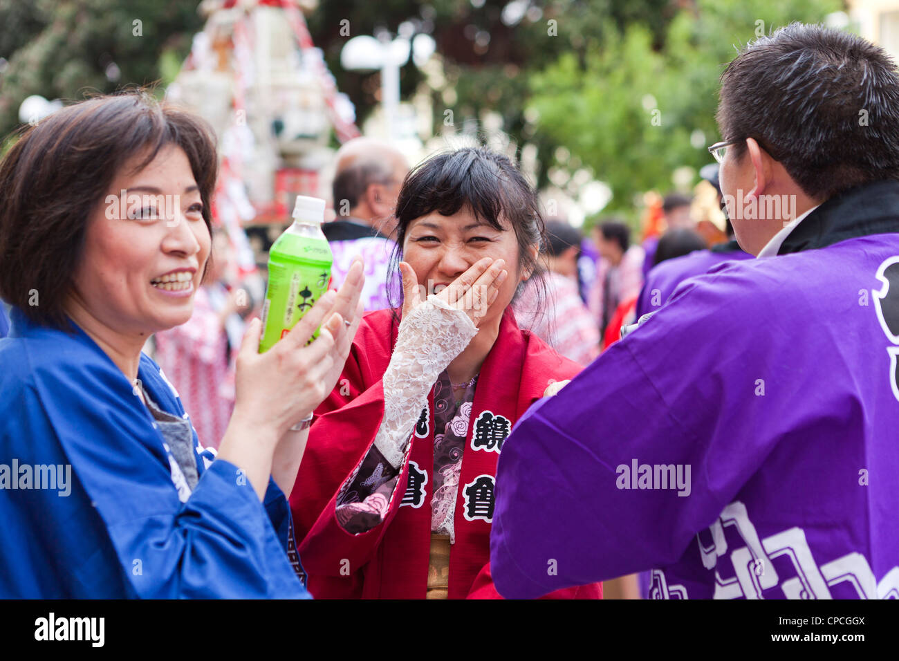 A Japanese woman covering her mouth while laughing Stock Photo Alamy
