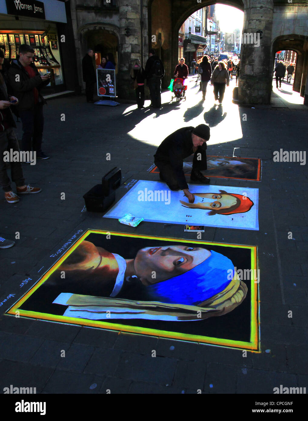 Artist at work drawing with chalk on the concrete blocks sets the