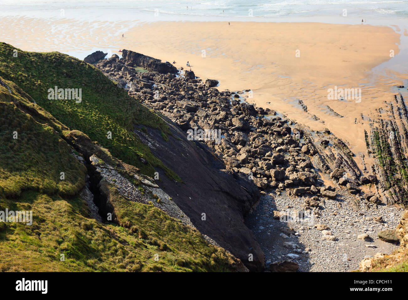 Rocks cracking and breaking away from the eroding cliffs above the beach at Bude, Cornwall, England, UK, Britain Stock Photo