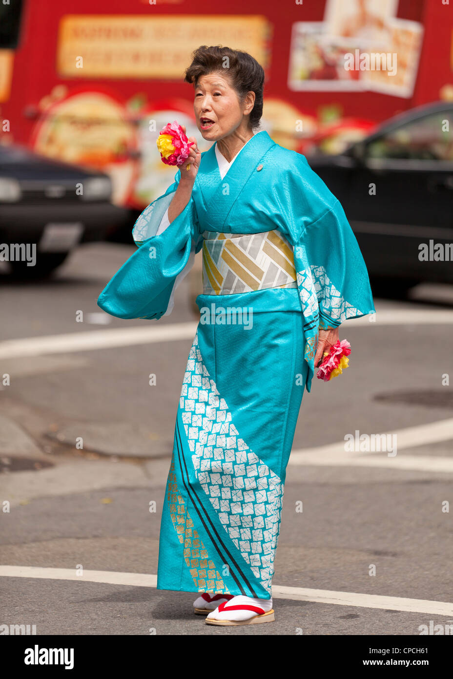 A middle aged Japanese woman wearing a kimono at a festival Stock Photo