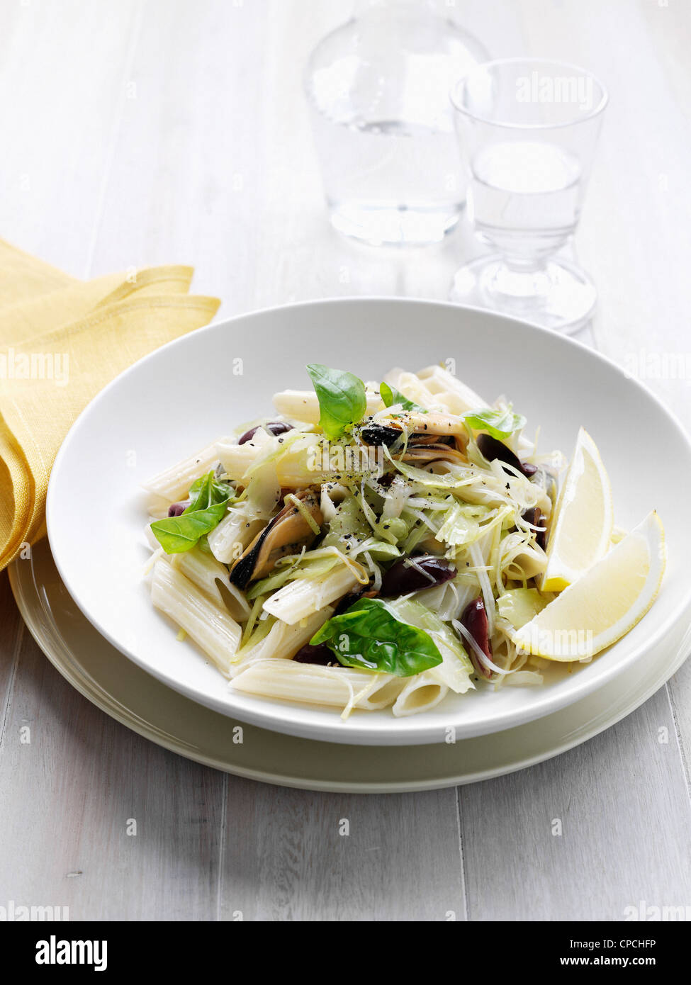 Bowl of pasta with olives and cheese Stock Photo