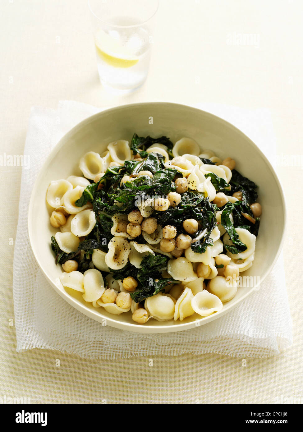 Bowl of pasta with spinach and beans Stock Photo