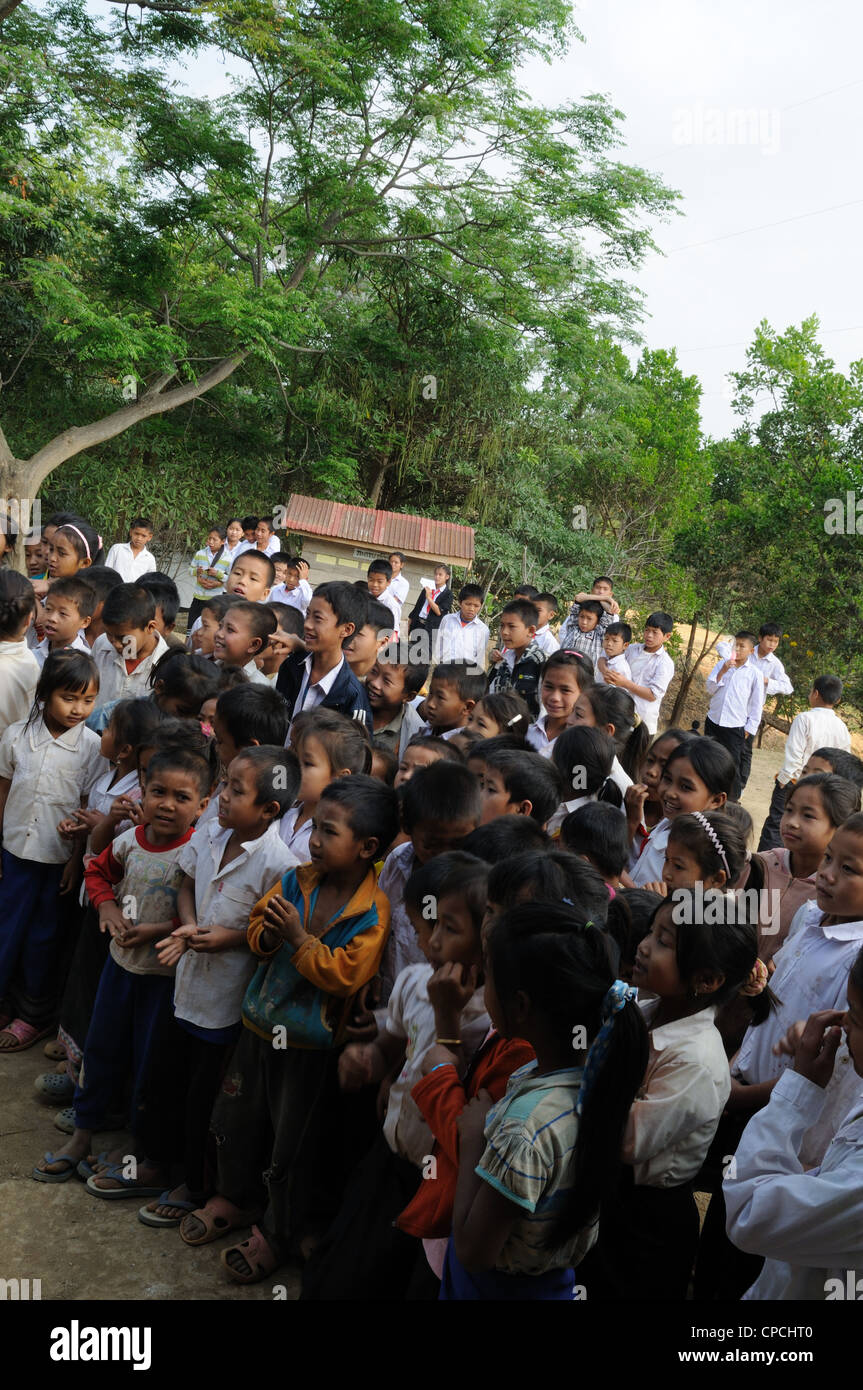 Lao school children during a presentation of books and stationary by tourists Ziemg Khuang Province Northern Laos Stock Photo