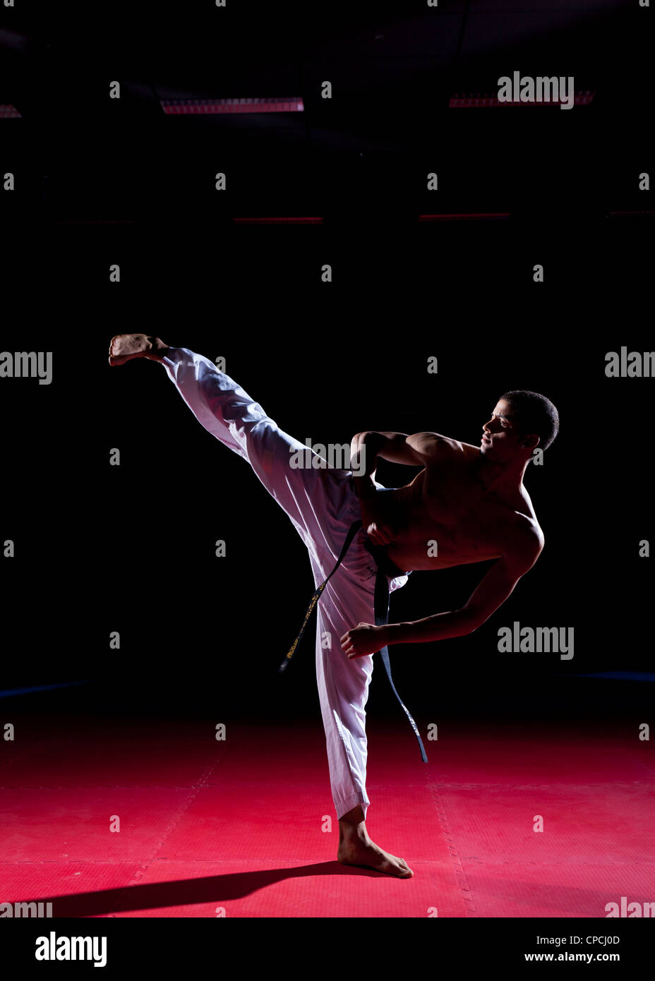 a men performing a high side-kick Stock Photo