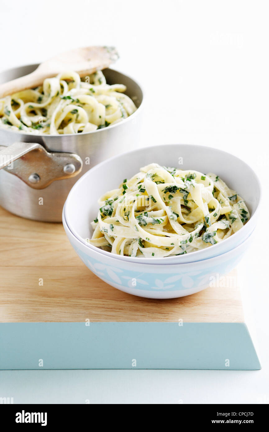 Bowl of pasta with herbs Stock Photo