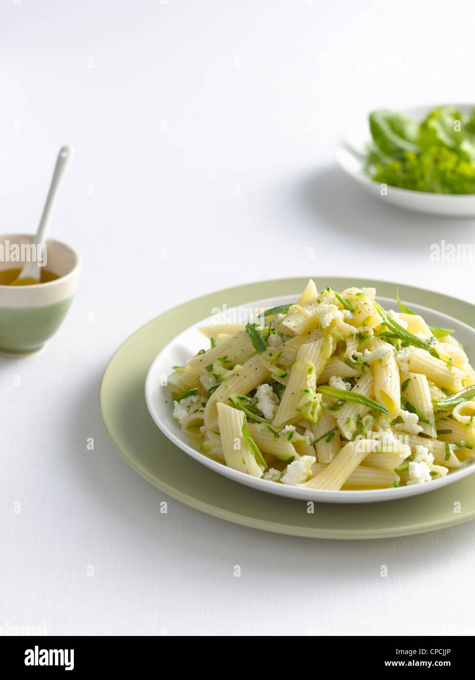 Bowl of pasta with cheese and herbs Stock Photo