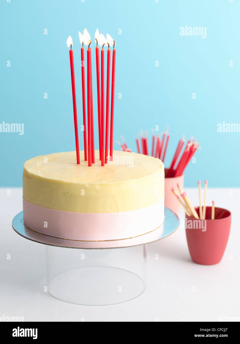 Decorated birthday cake with lit candles Stock Photo Alamy