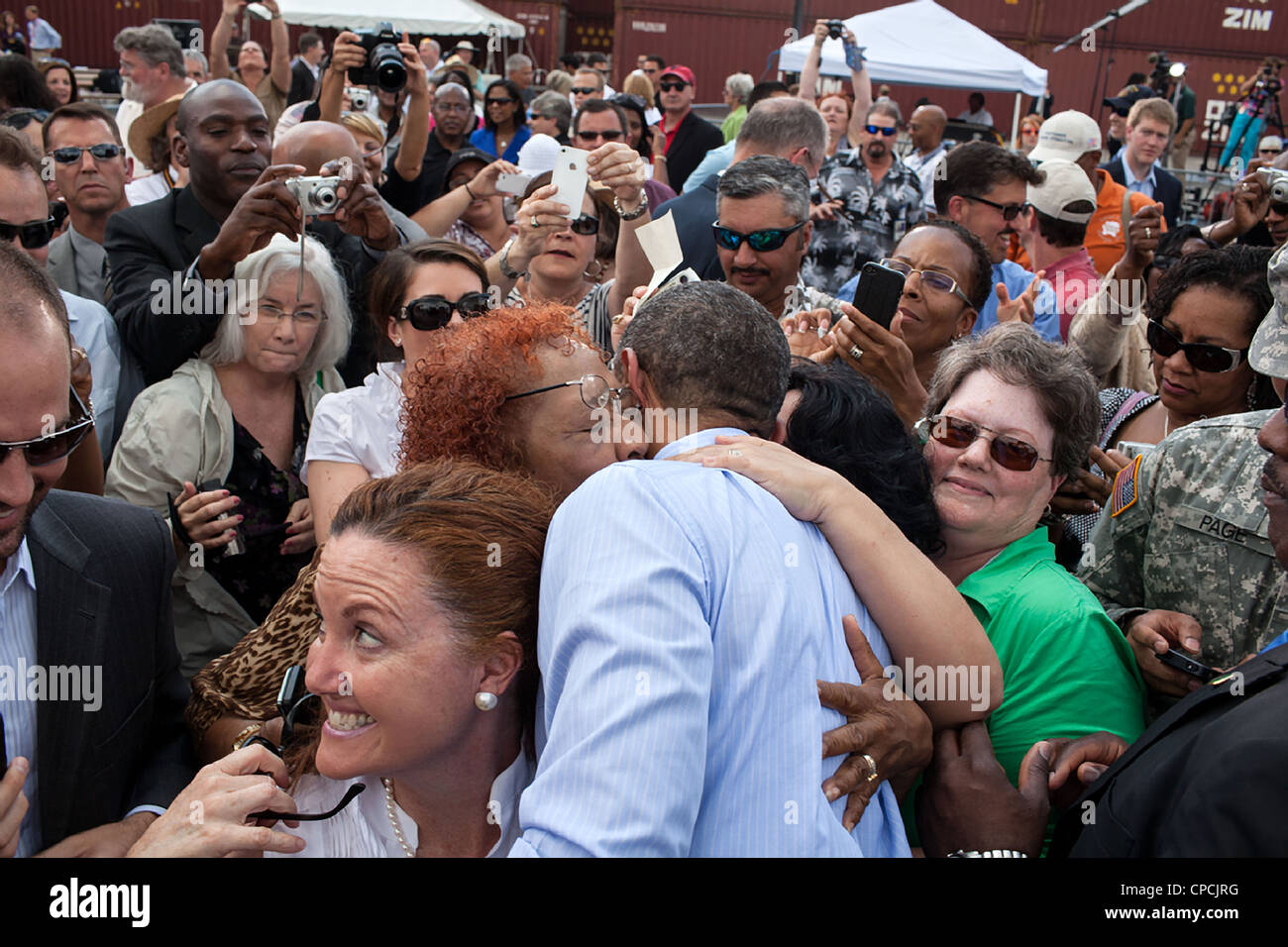 US President Barack Obama is embraced by supporters after speaking at the Port of Tampa April 13, 2012 in Tampa, Florida. Stock Photo