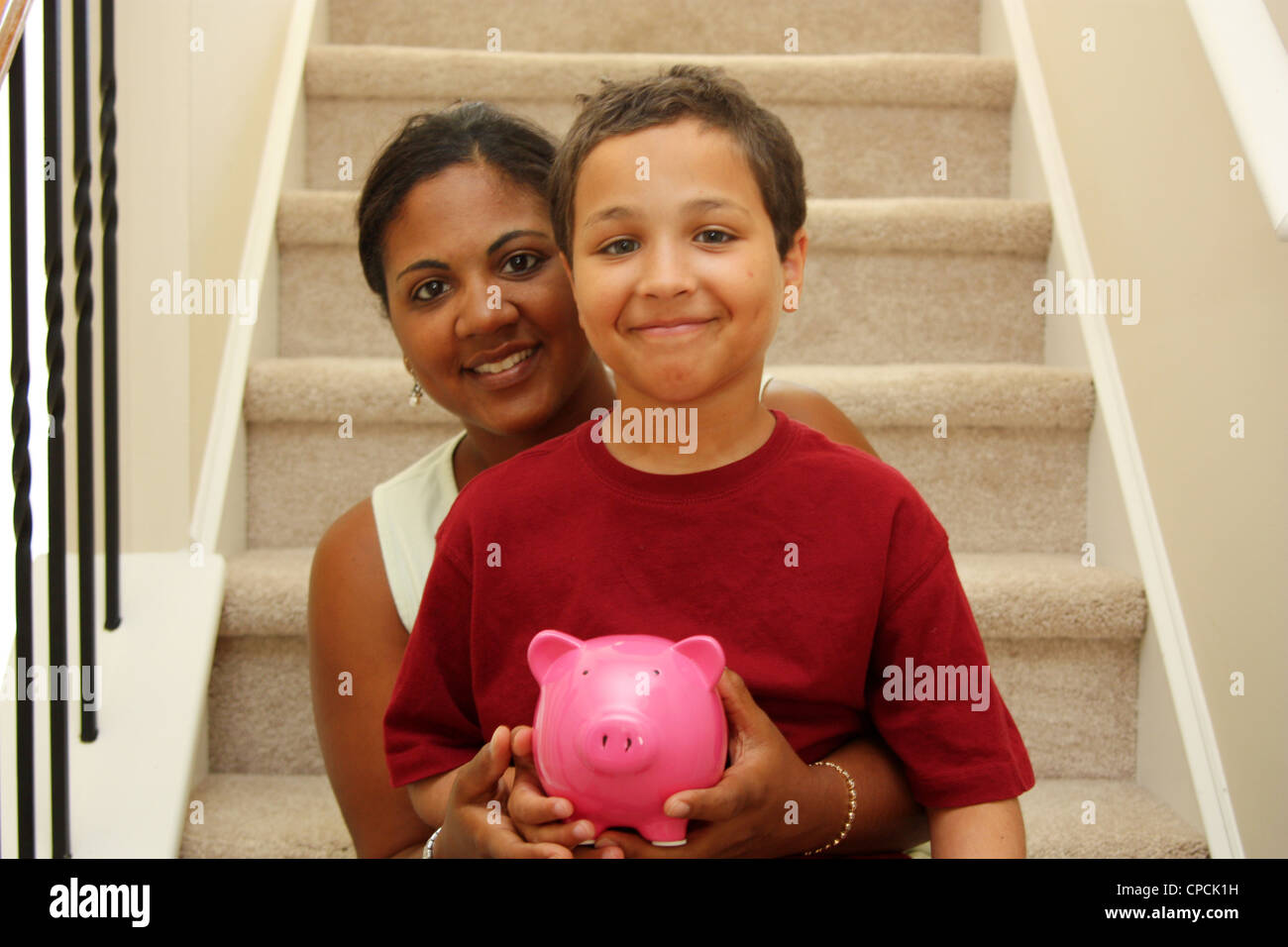 Woman and Son Holding Piggy Bank With Savings Stock Photo - Alamy