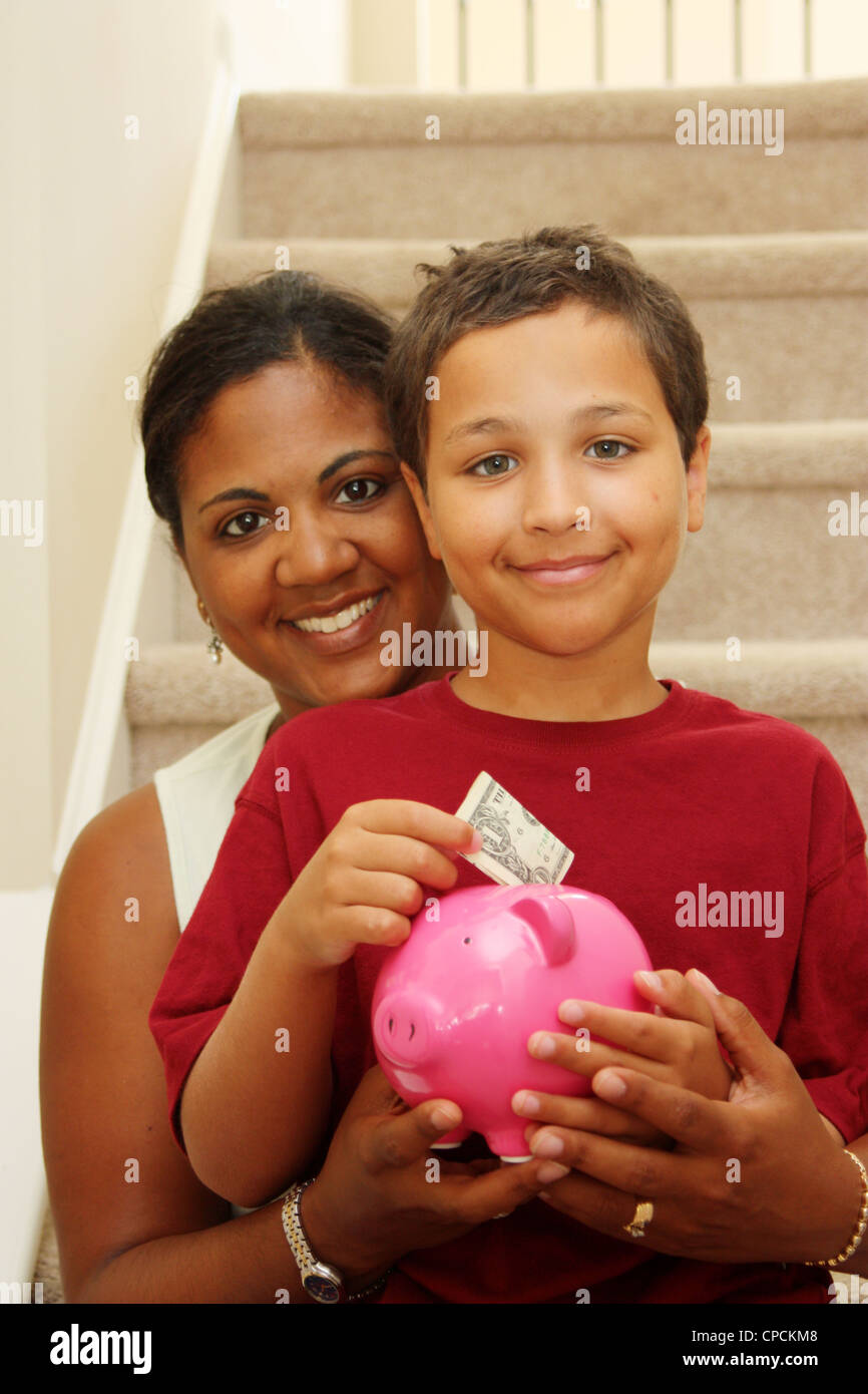 Woman And Son Holding Piggy Bank With Their Savings Stock Photo - Alamy