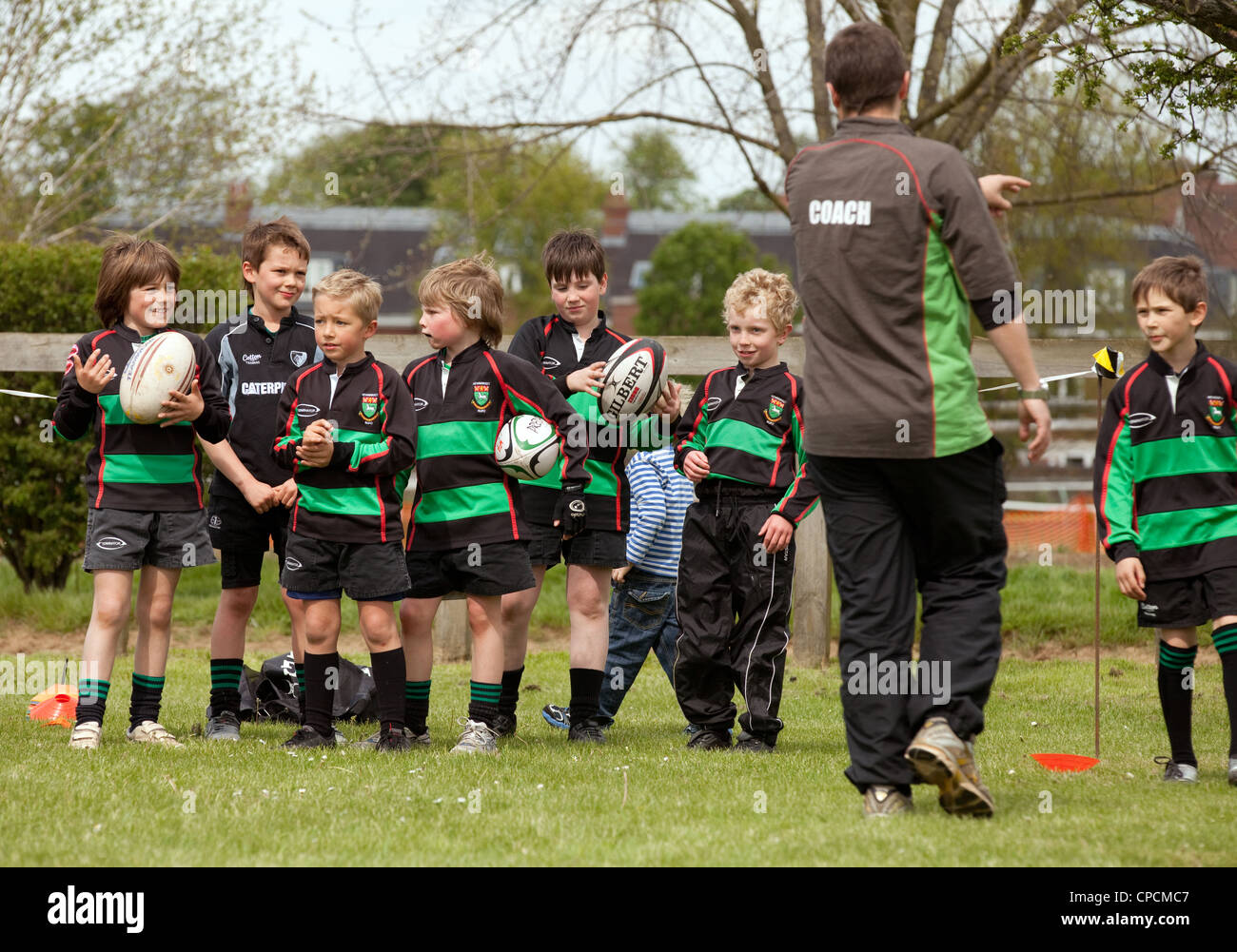 Rugby coach coaching children - Newmarket Juniors Club, Suffolk UK Stock Photo