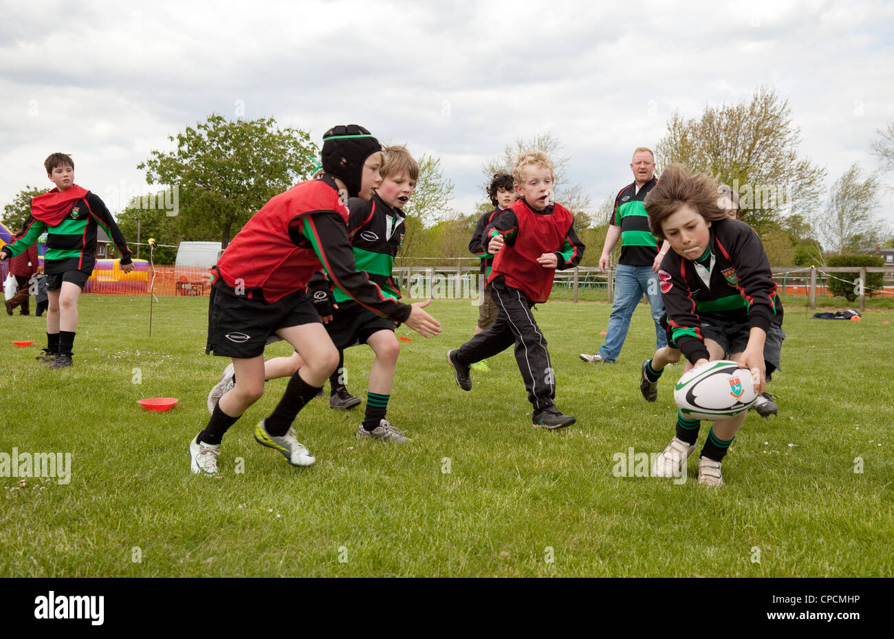 Child junior playing rugby and scoring a try, Newmarket Juniors, Suffolk UK Stock Photo