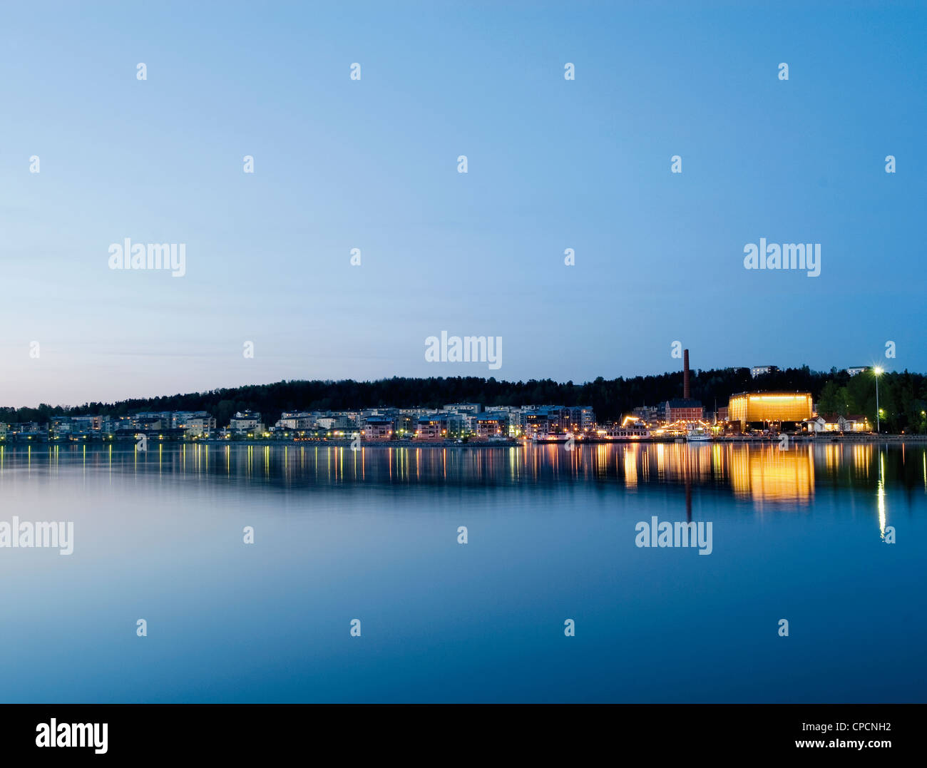 City lights reflected in still water Stock Photo