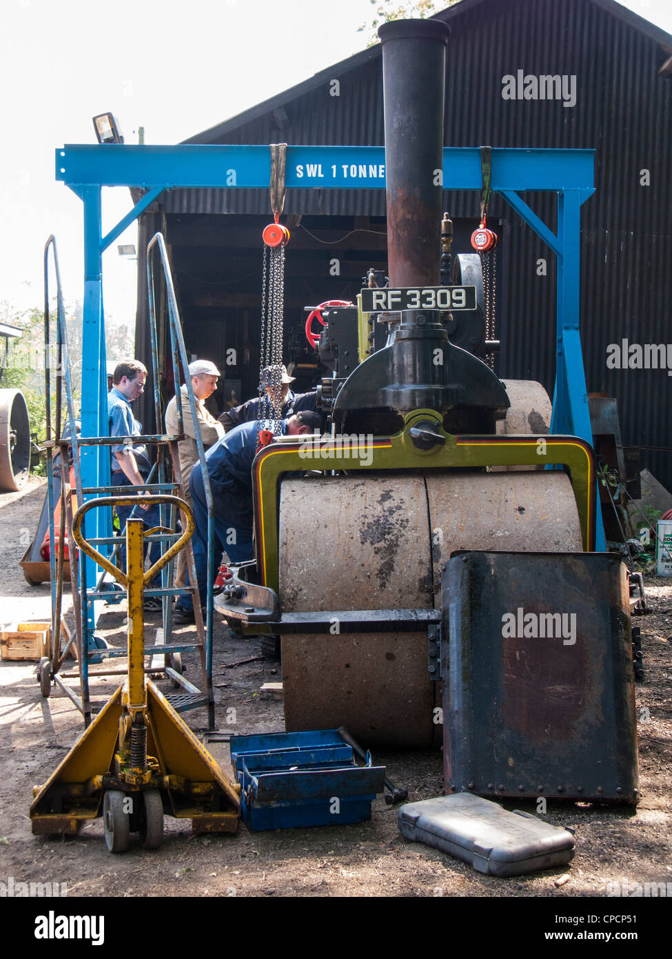 Engine men restoring an old steam engine Stock Photo Alamy