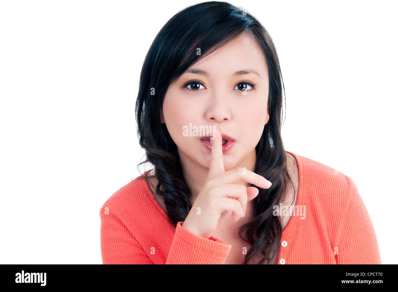 Attractive young woman showing finger over her lips Stock Photo