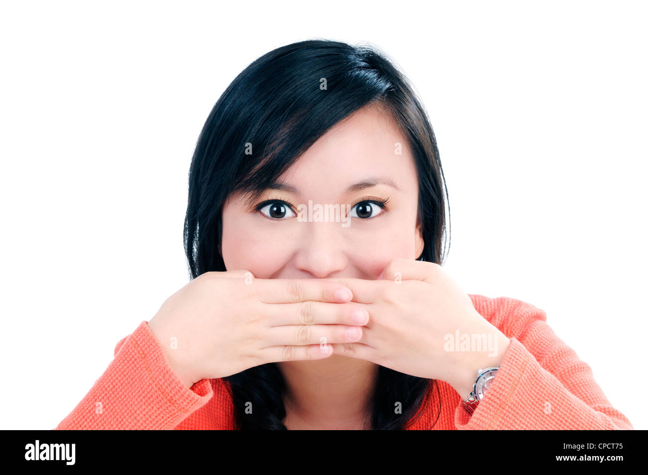 Cute woman covering her mouth with both hands Stock Photo