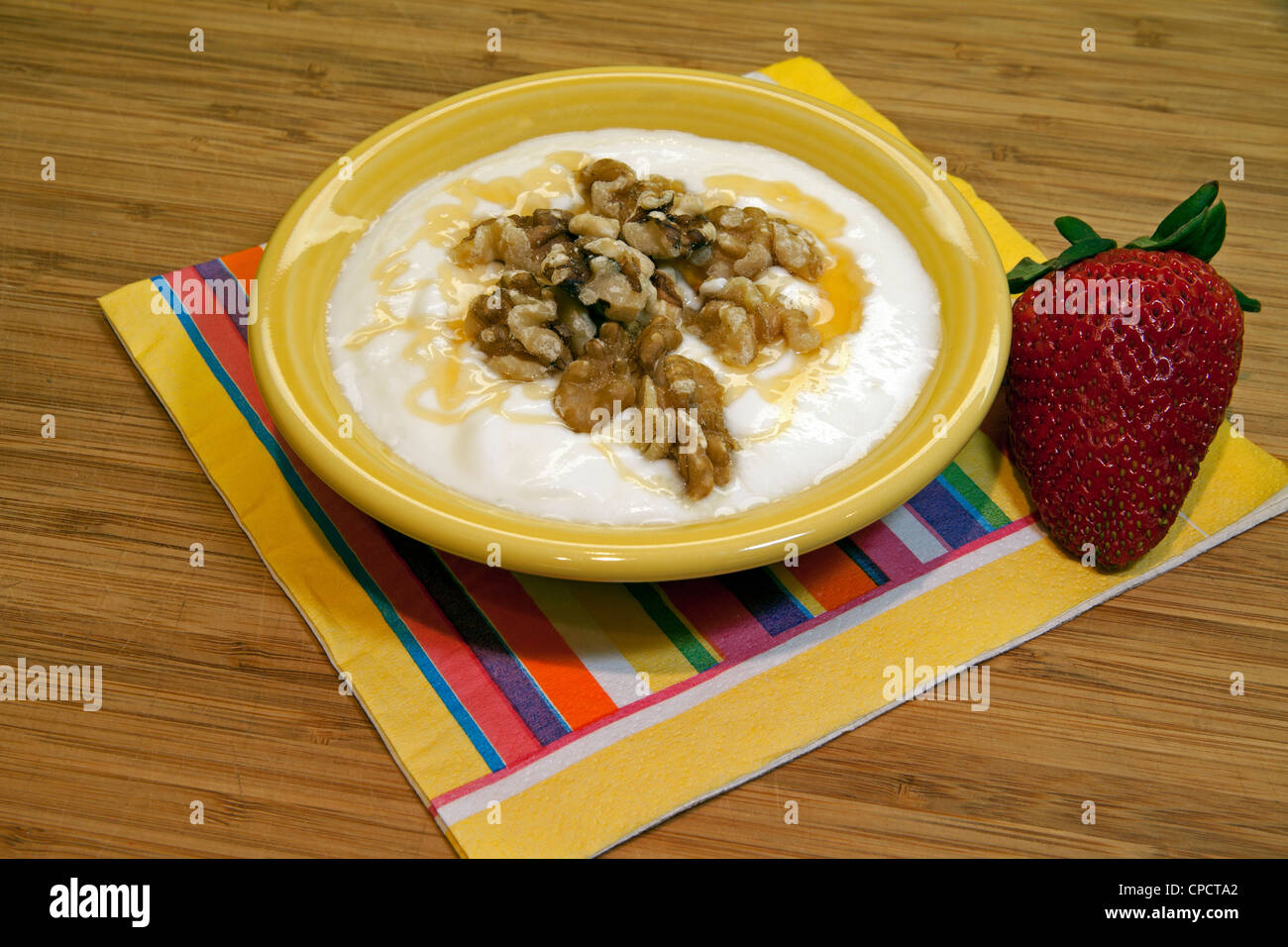 Serving of Creamery Yogurt and Cheese with walnuts and strawberry USA