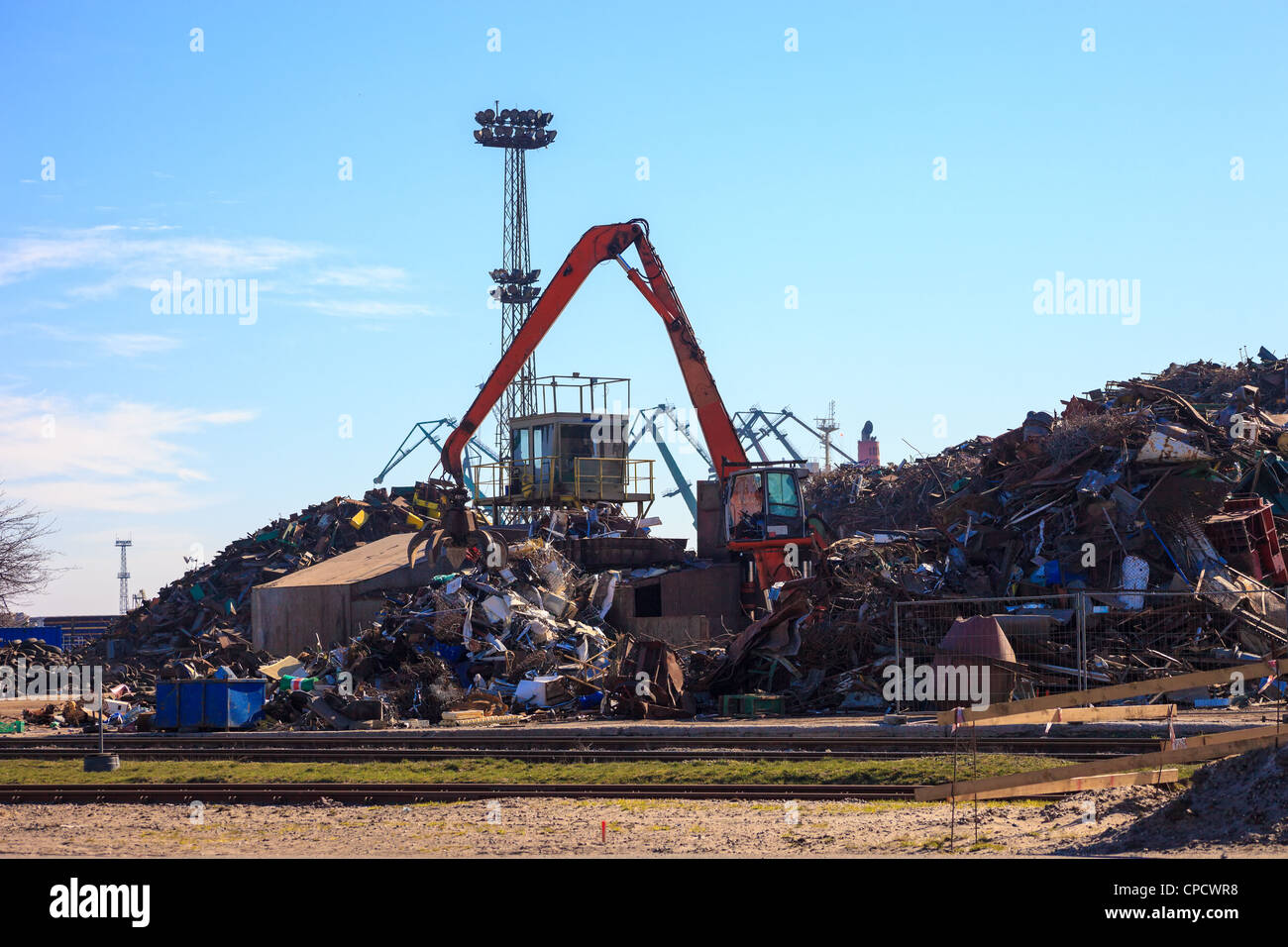 Mechanical crane grabber working in a scrapyard. Stock Photo