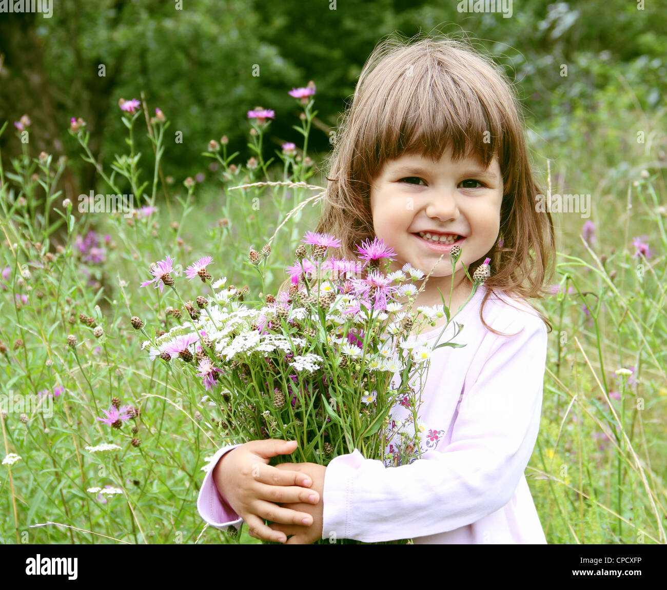 Little Smiling Girl with Bunch of Flowers Portrait Stock Photo - Alamy