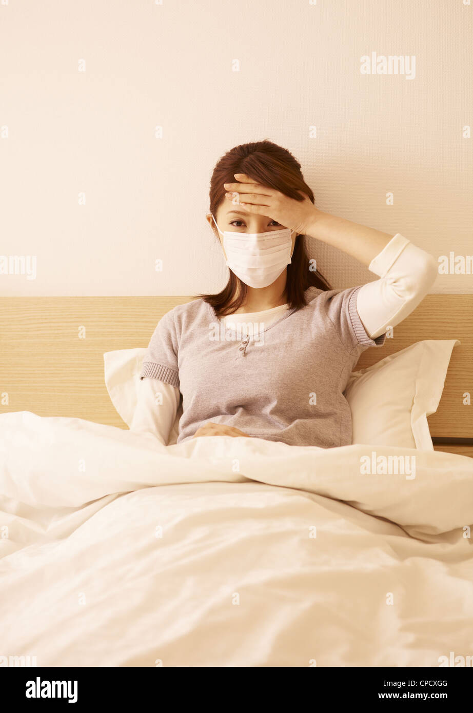 Woman wearing mask in bed Stock Photo Alamy