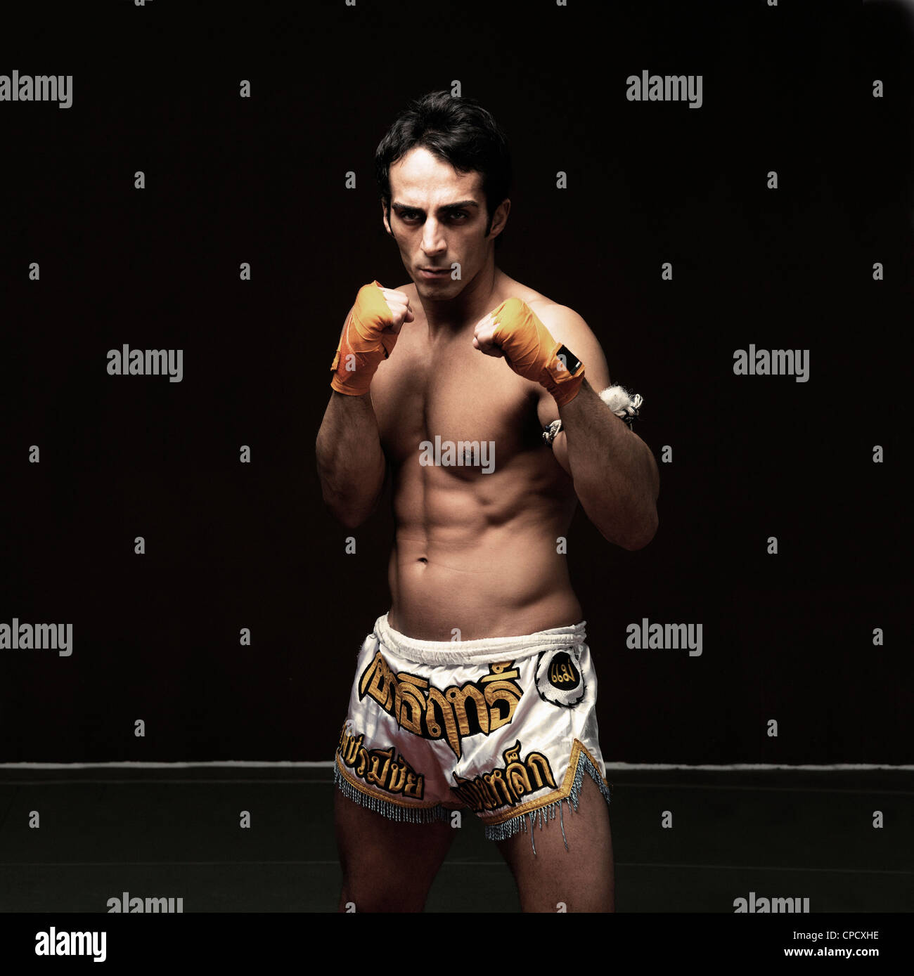 Boxer standing with raised fists Stock Photo