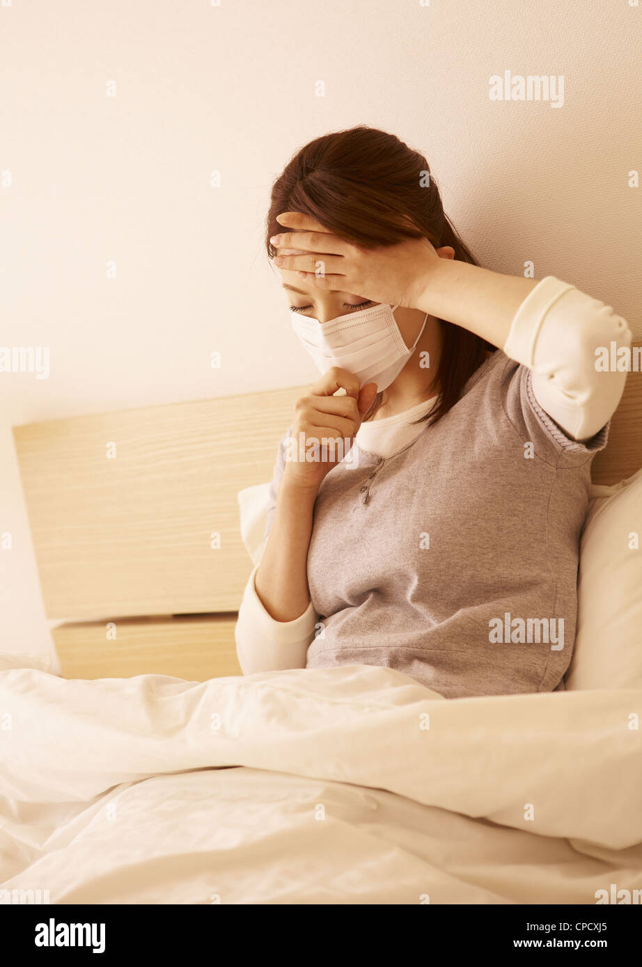 Woman wearing mask in bed Stock Photo Alamy